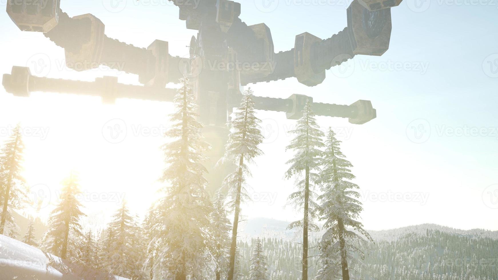 UFO hovering over a forest at sunset with light beam photo
