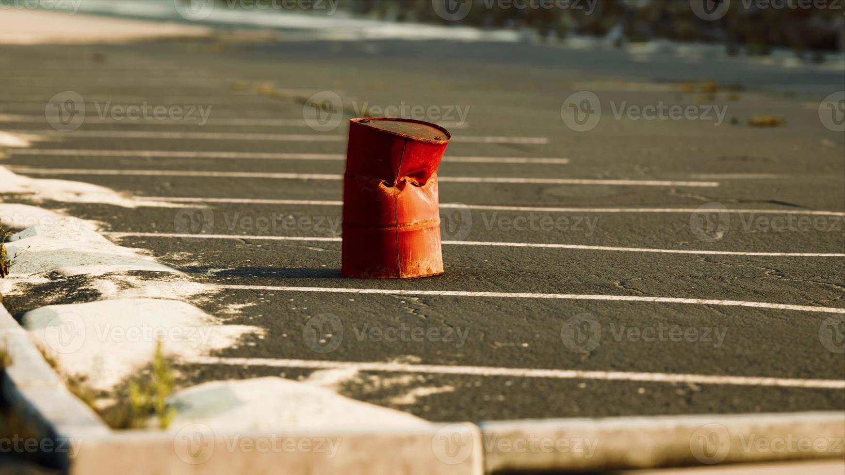 old and rusty metal barrel on parking photo