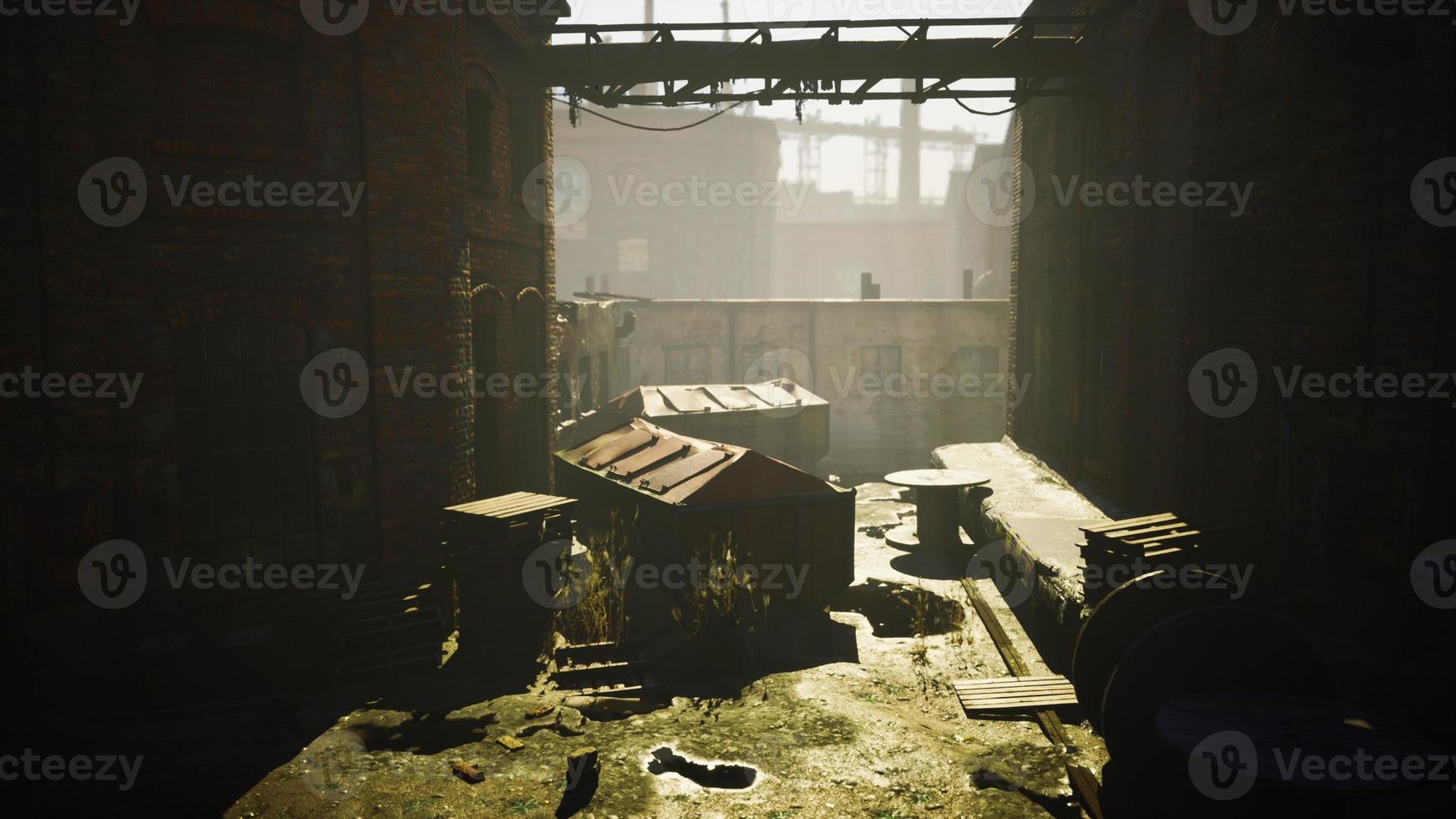 Abandoned factory with concrete ruins in industrial district photo