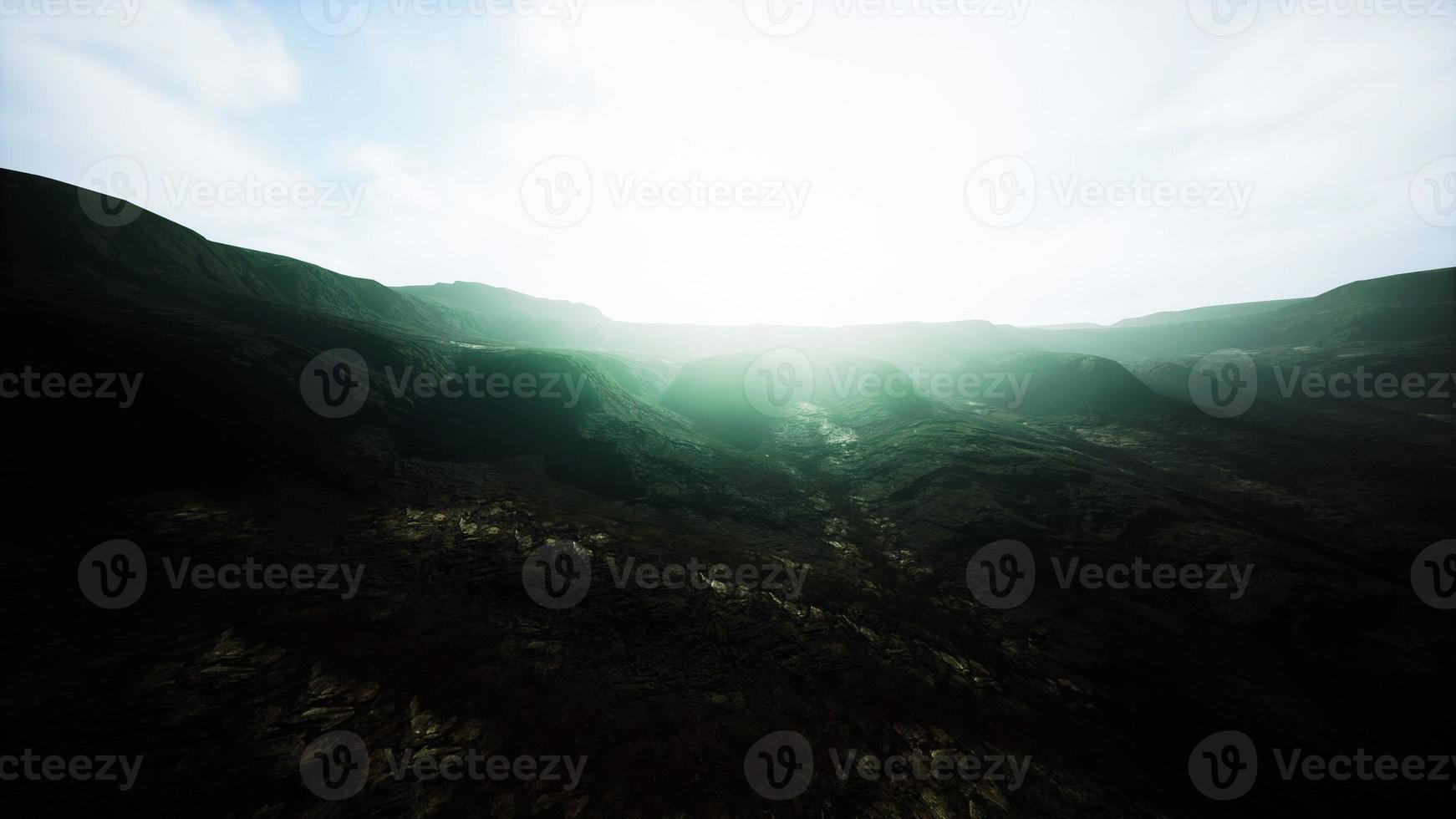 dark atmospheric landscape with high black mountain top in fog photo