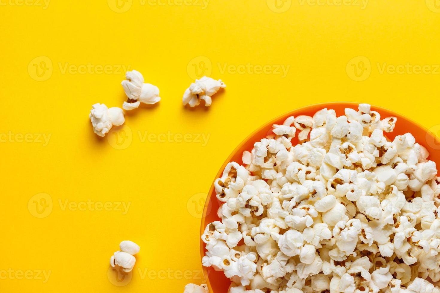 Popcorn in an orange bowl. photo