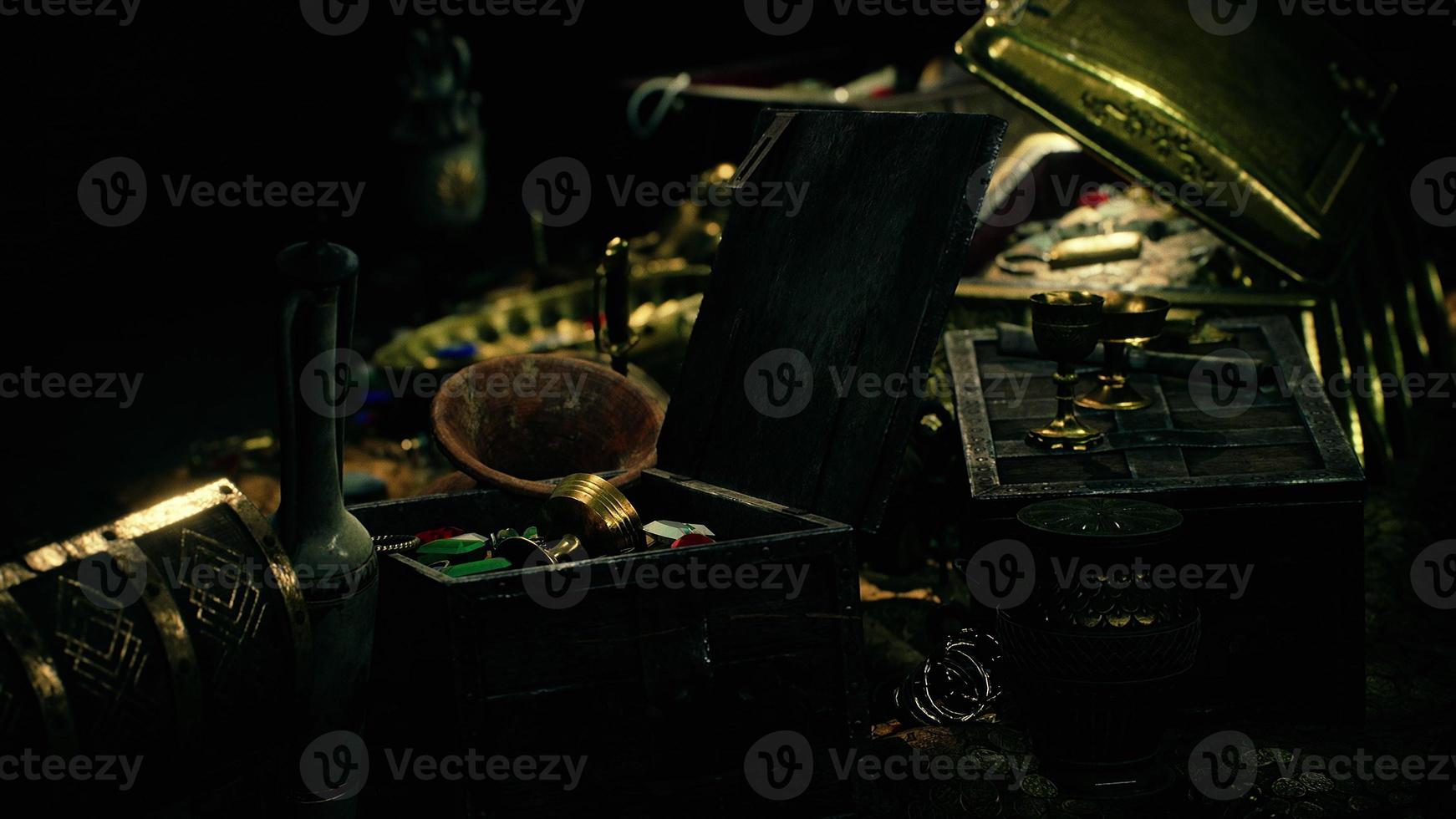 treasures in a dark cave with coins diamonds and gold photo