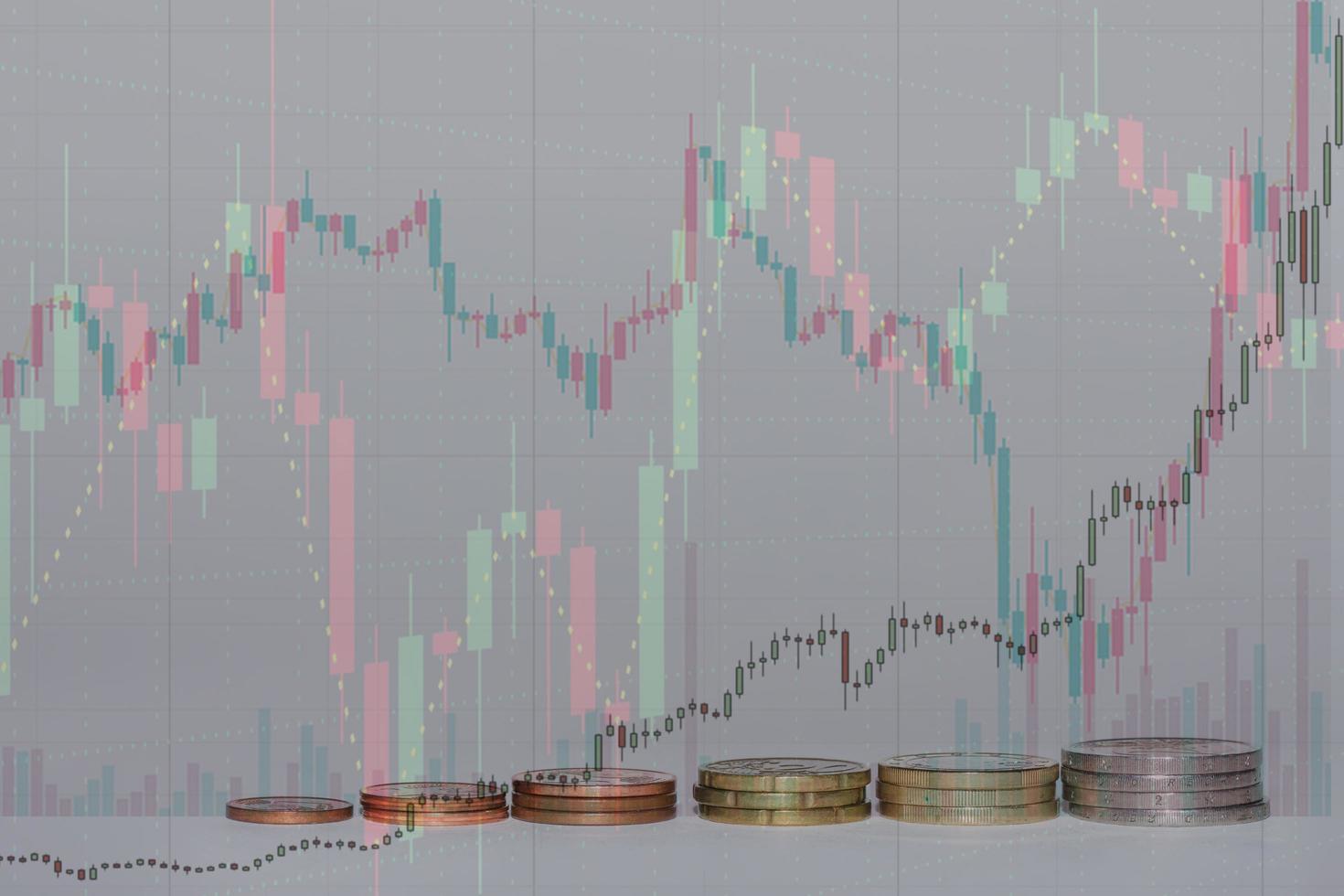 euro coins stacked in a row increasing in value with many charts and gray background photo