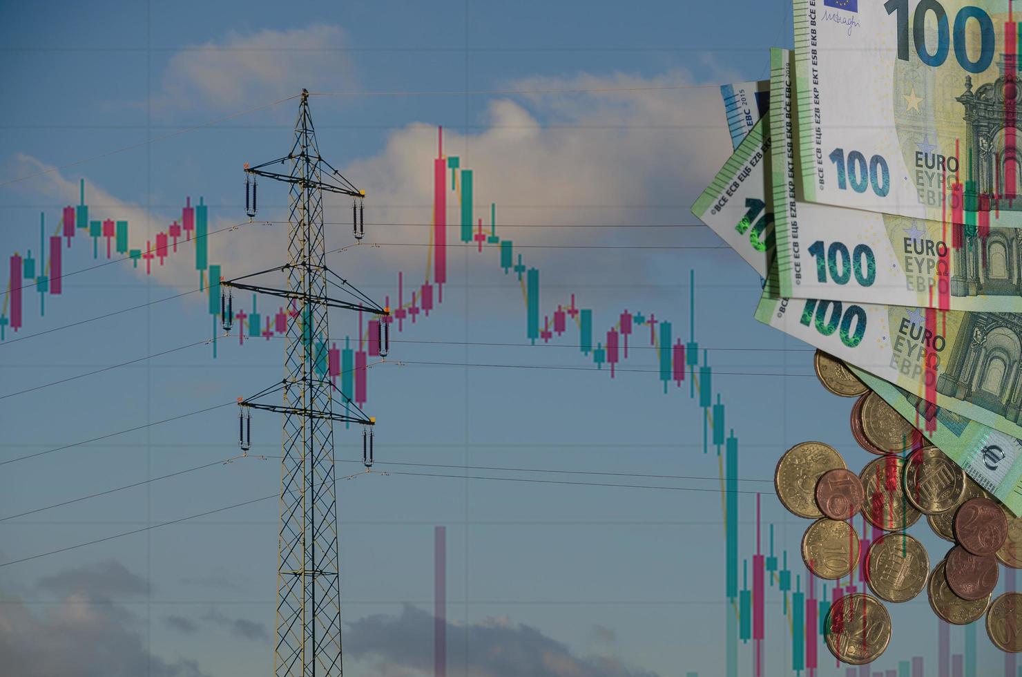 single electricity pylon with many euro bills and coins and a chart from the market regarding electricity price increases photo