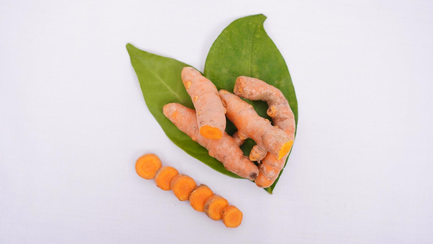 pieces of turmeric and bay leaf isolated on white background photo