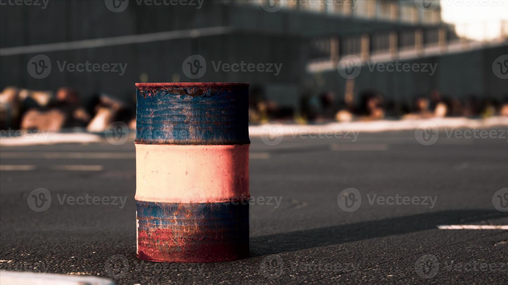 old and rusty metal barrel on parking photo