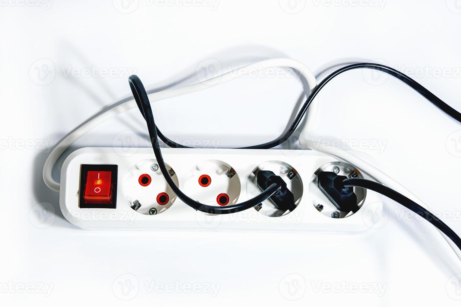 Extension cord with a button on a white background. Isolate. Copy space.View from above. Flat lay. photo