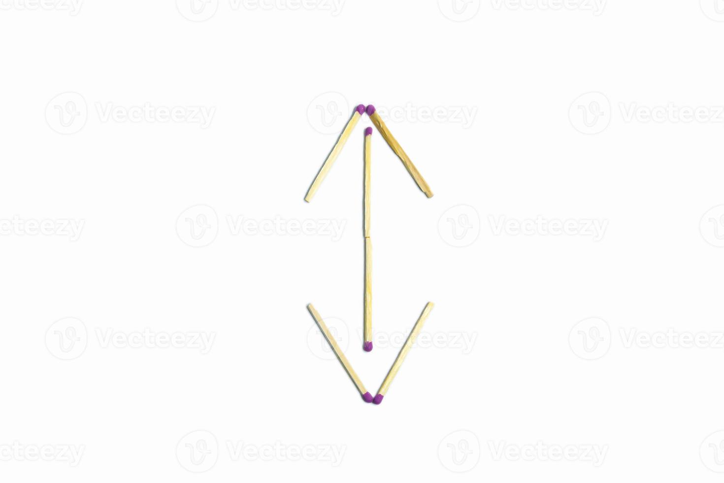 The figure of a double-sided arrow on a white background, lined with matches. Isolate. photo