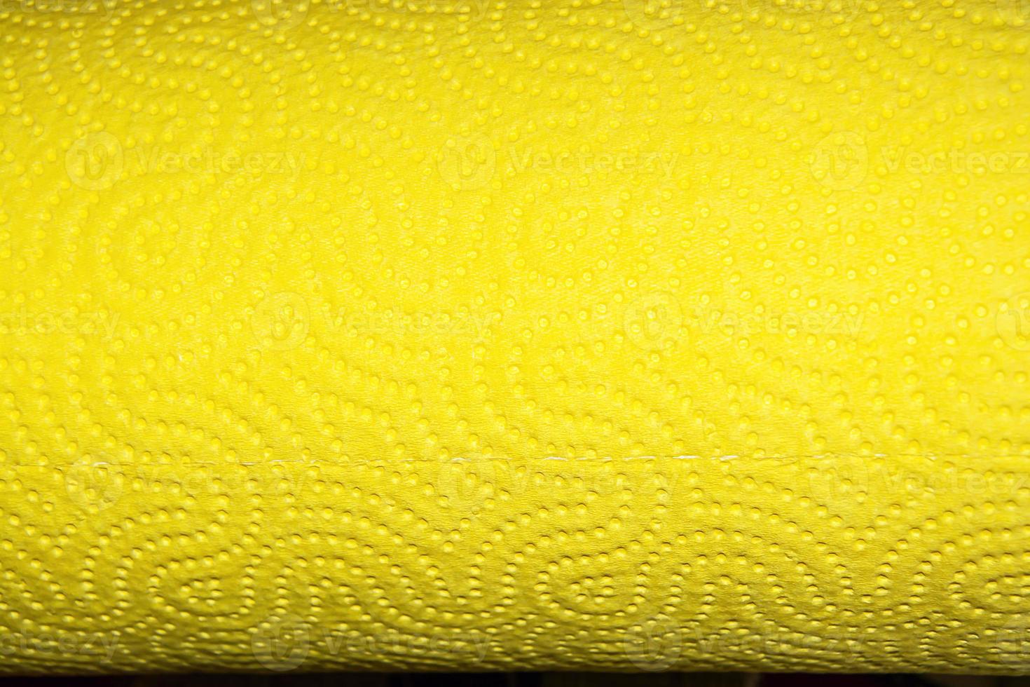 Abstract background texture of perforated paper in yellow color. Copy space. photo