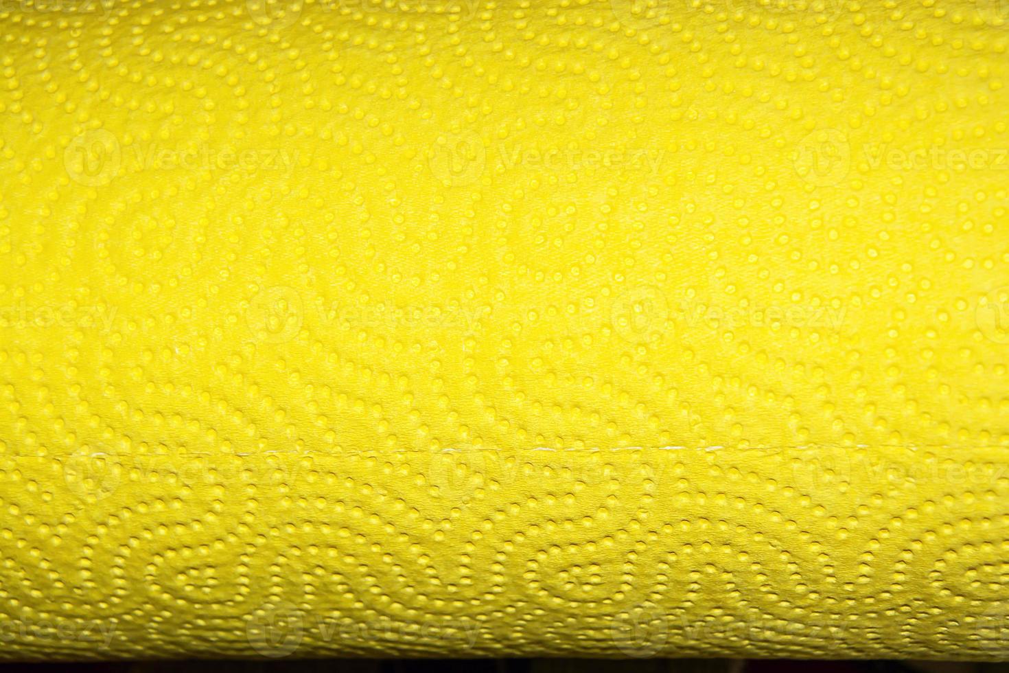 Abstract background texture of perforated paper in yellow color. Copy space. photo