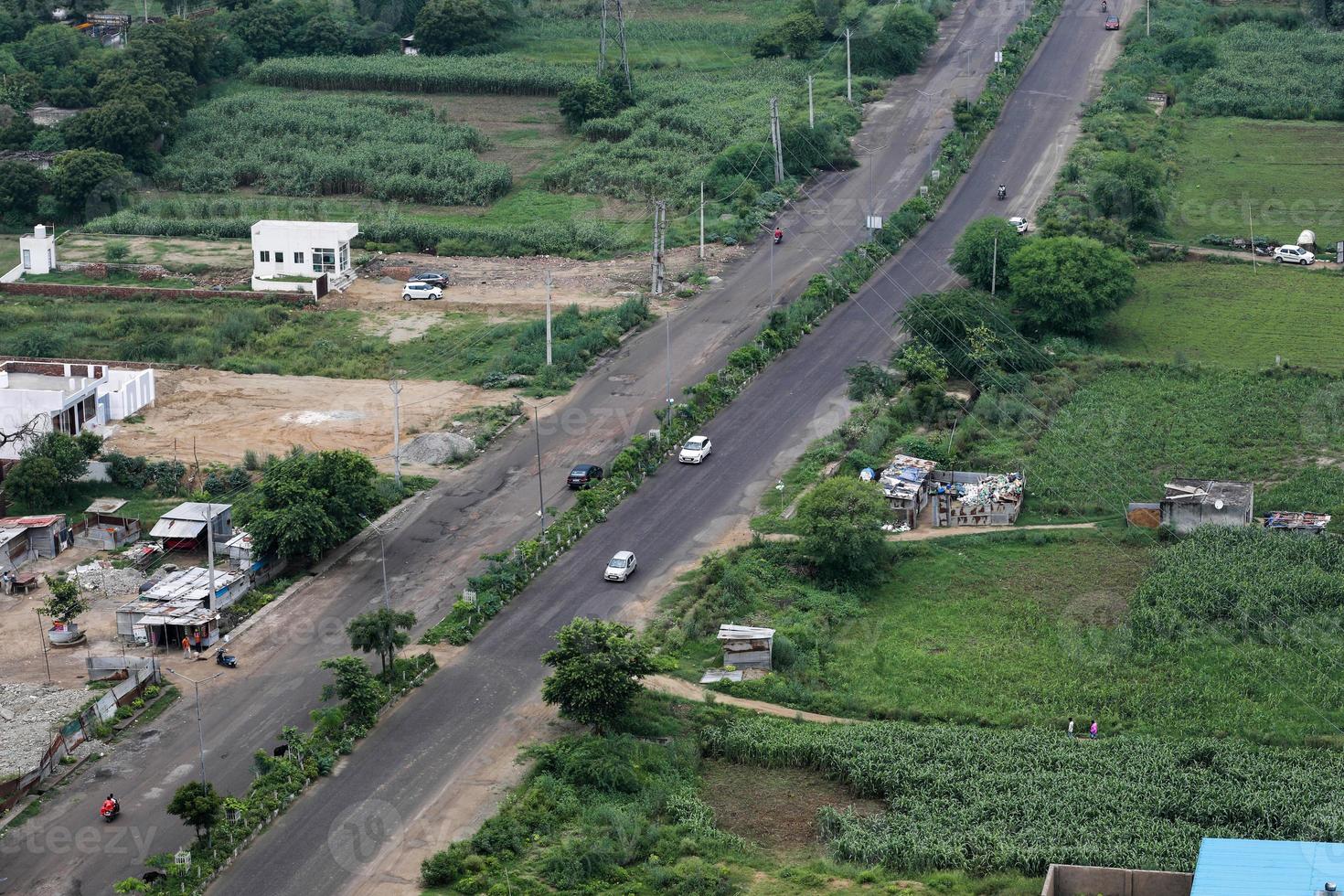 aerial view of a road in between the fields. photo
