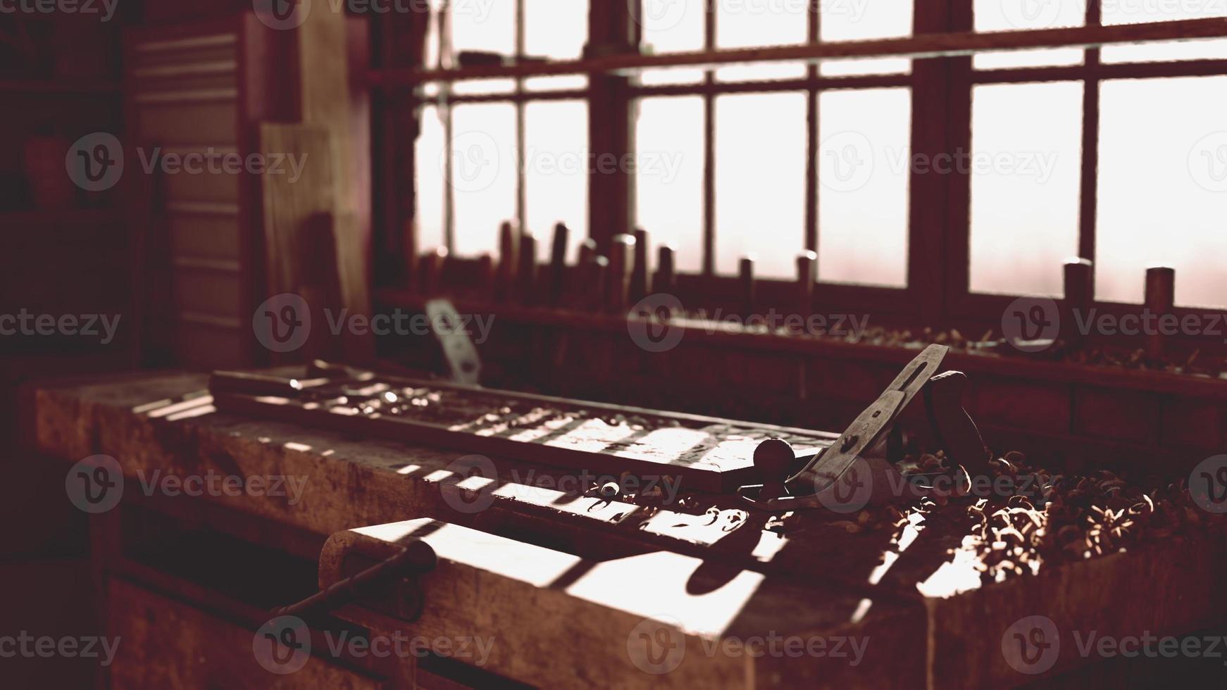 Retro stylized old tools on wooden table in a joinery photo