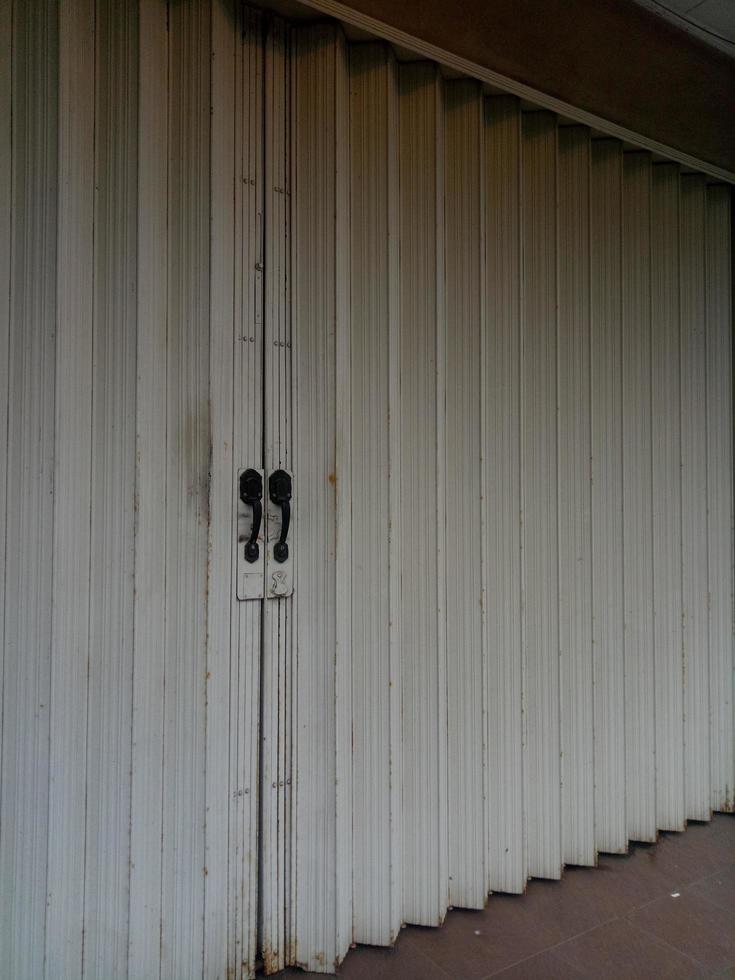 Dull and rusty white folding door photo