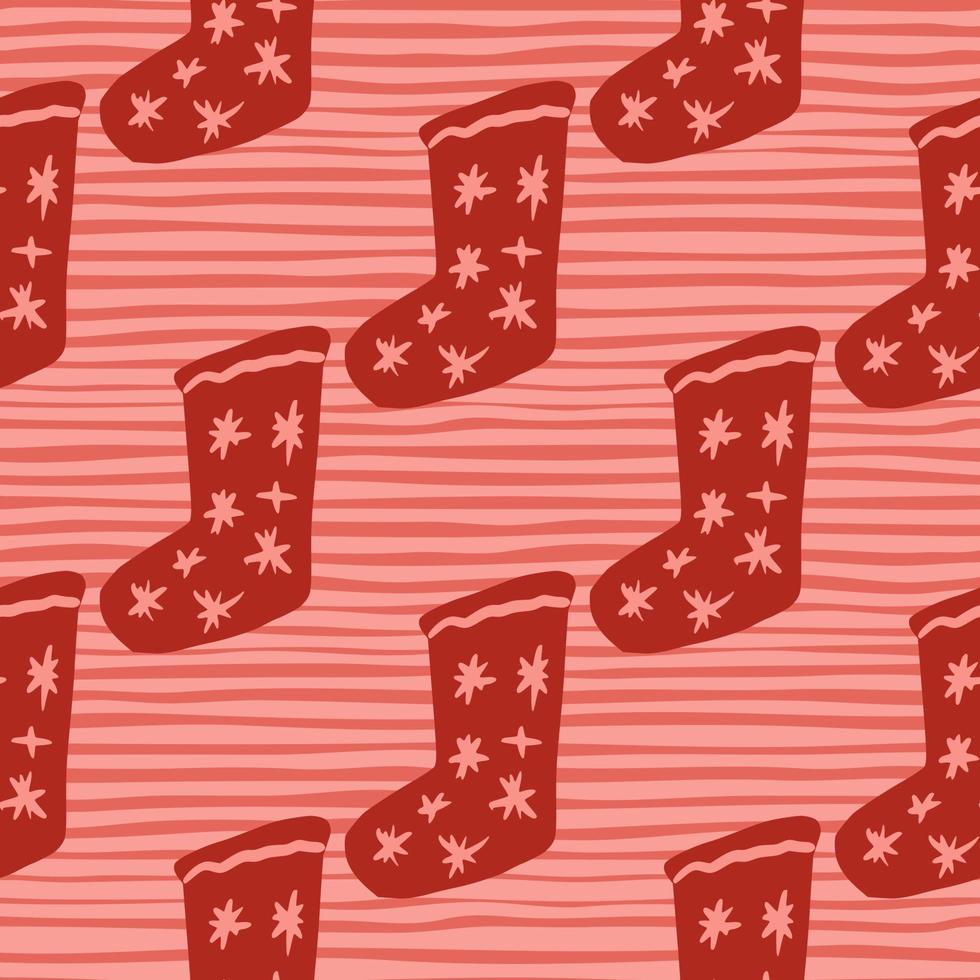 Red colored christmas socks with stars ornament seamless pattern. Doodle new year december print on stripped background. vector