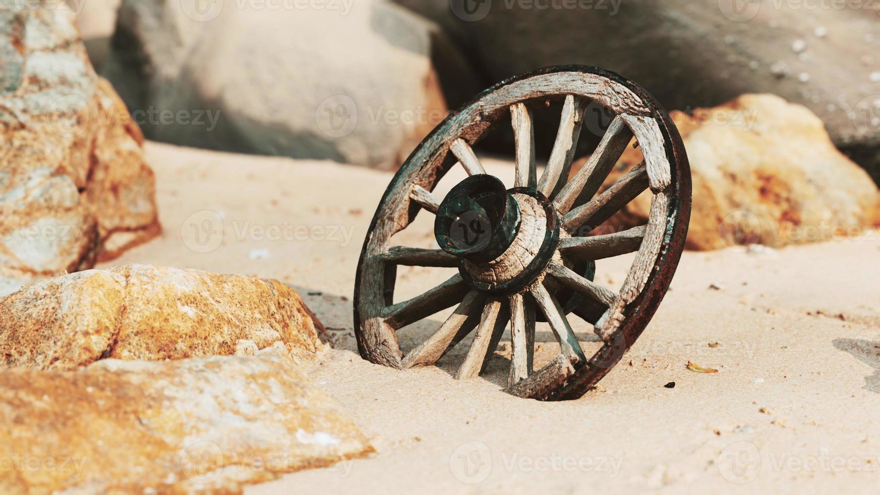 old tradition waggon wheel on the sand photo