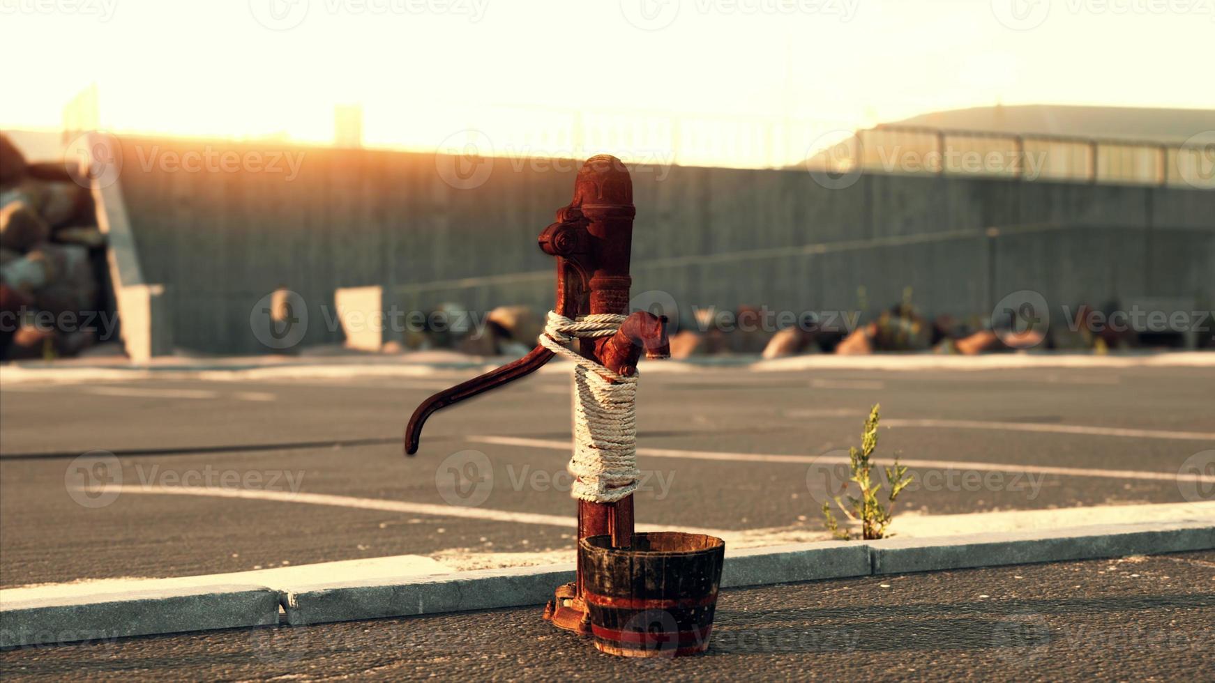 old rusty water pump at sunny day photo