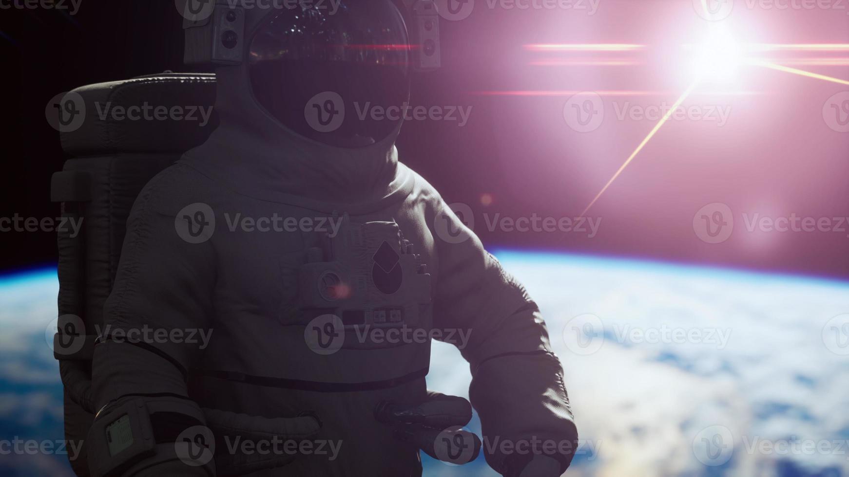 Space man astronaut in space on a background of the blue planet Earth photo