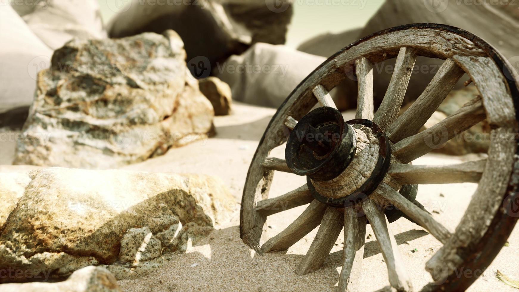 old tradition waggon wheel on the sand photo