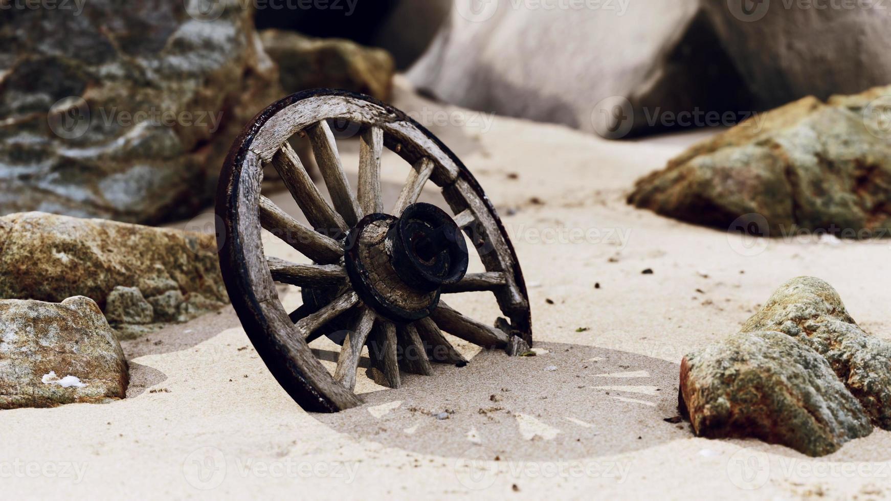 old tradition waggon wheel on the sand photo