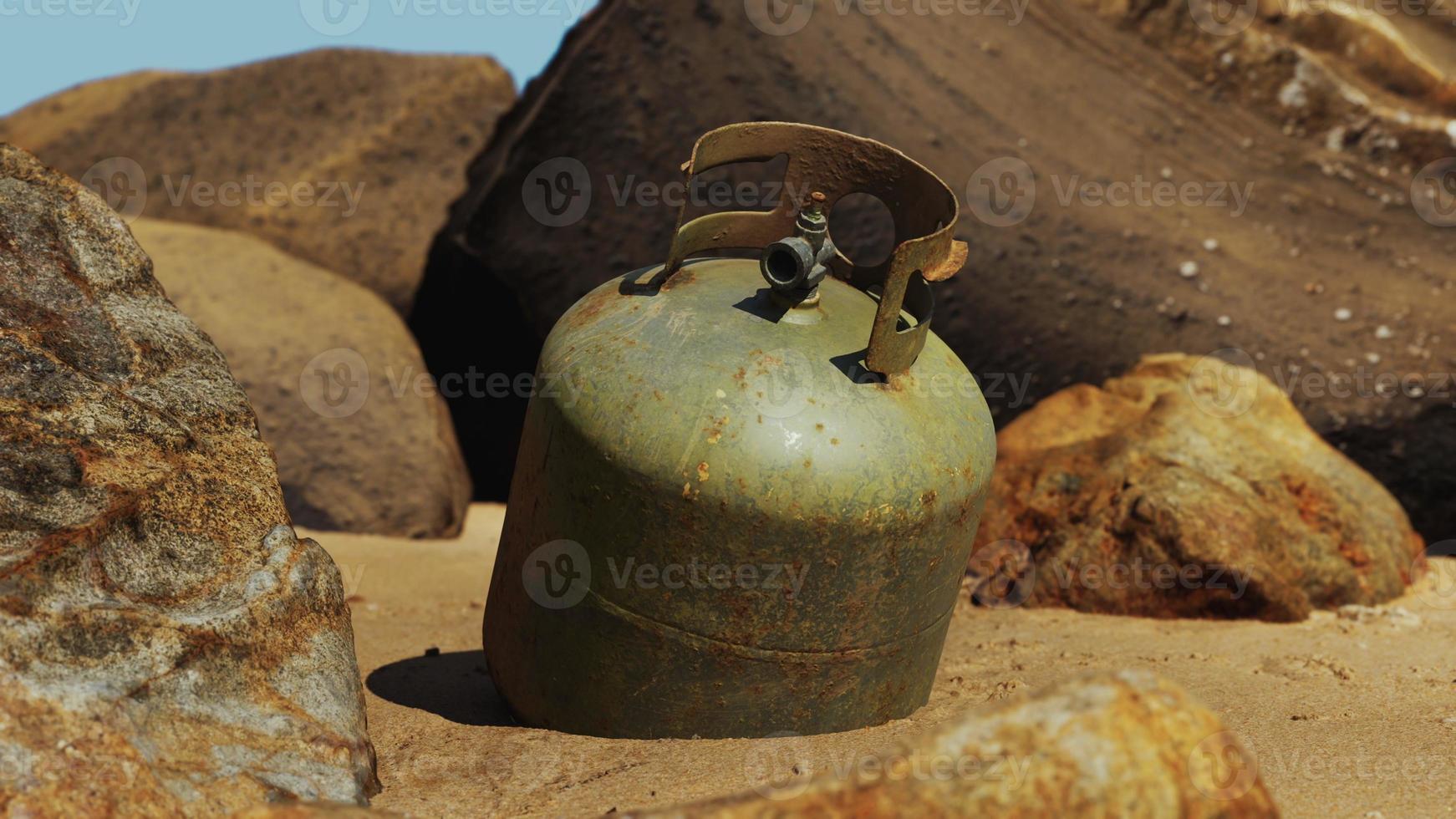 old cooking gas cylinder on sand beach photo