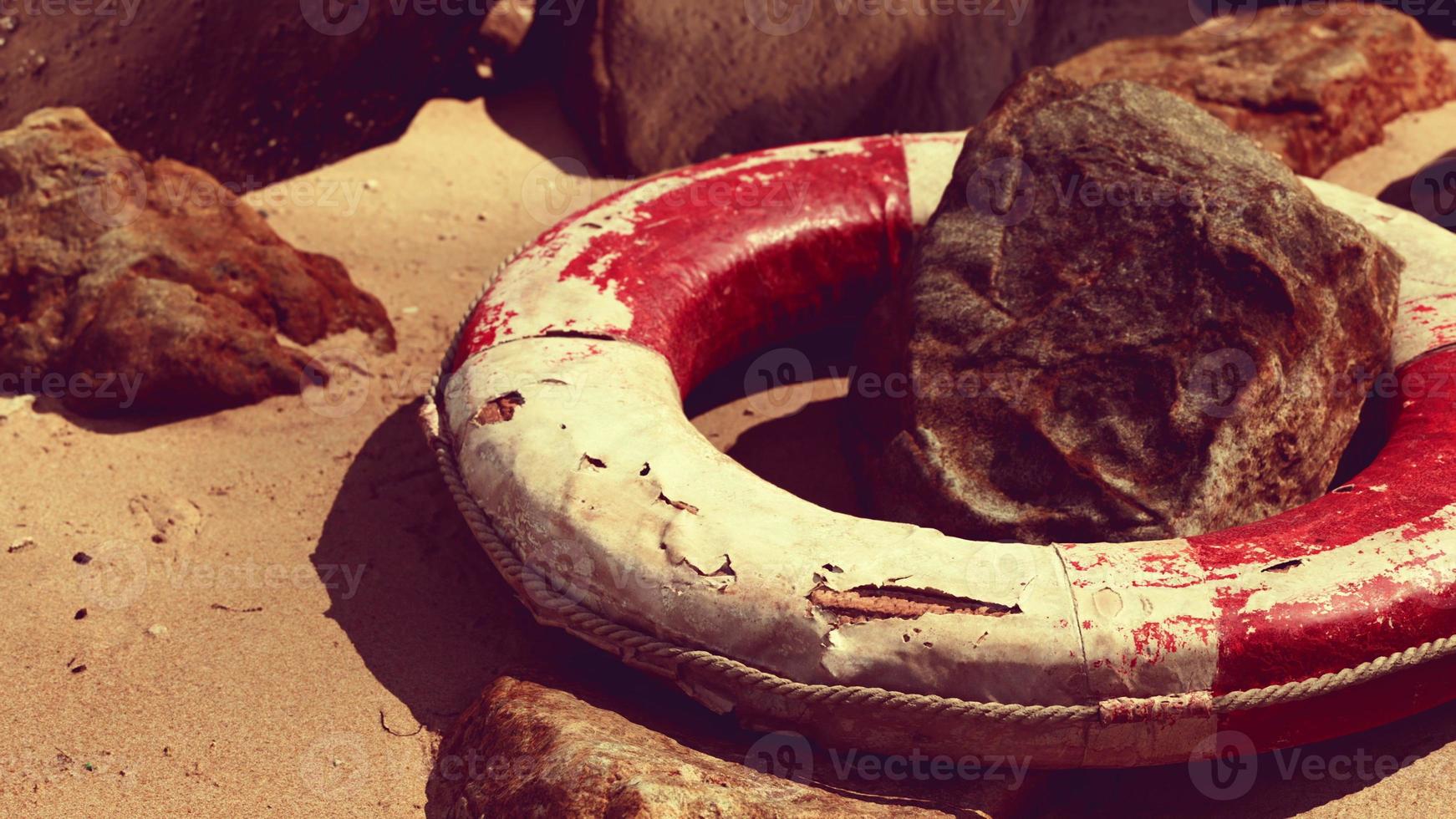 old broken Lifebuoy on sea beach photo