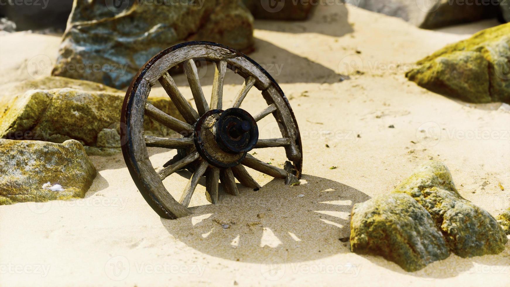 old tradition waggon wheel on the sand photo