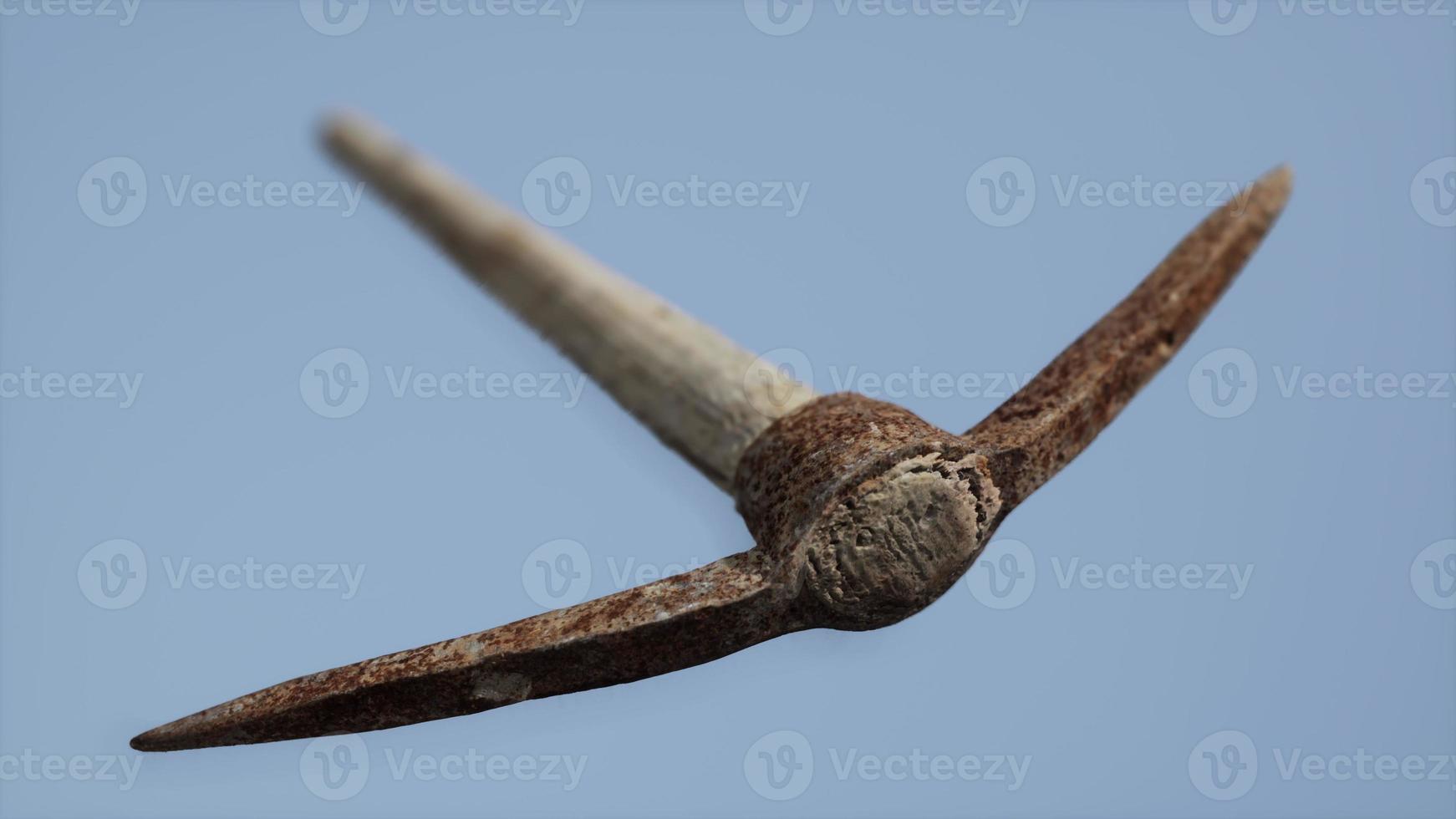 Close up of an old rusted pickaxe head photo