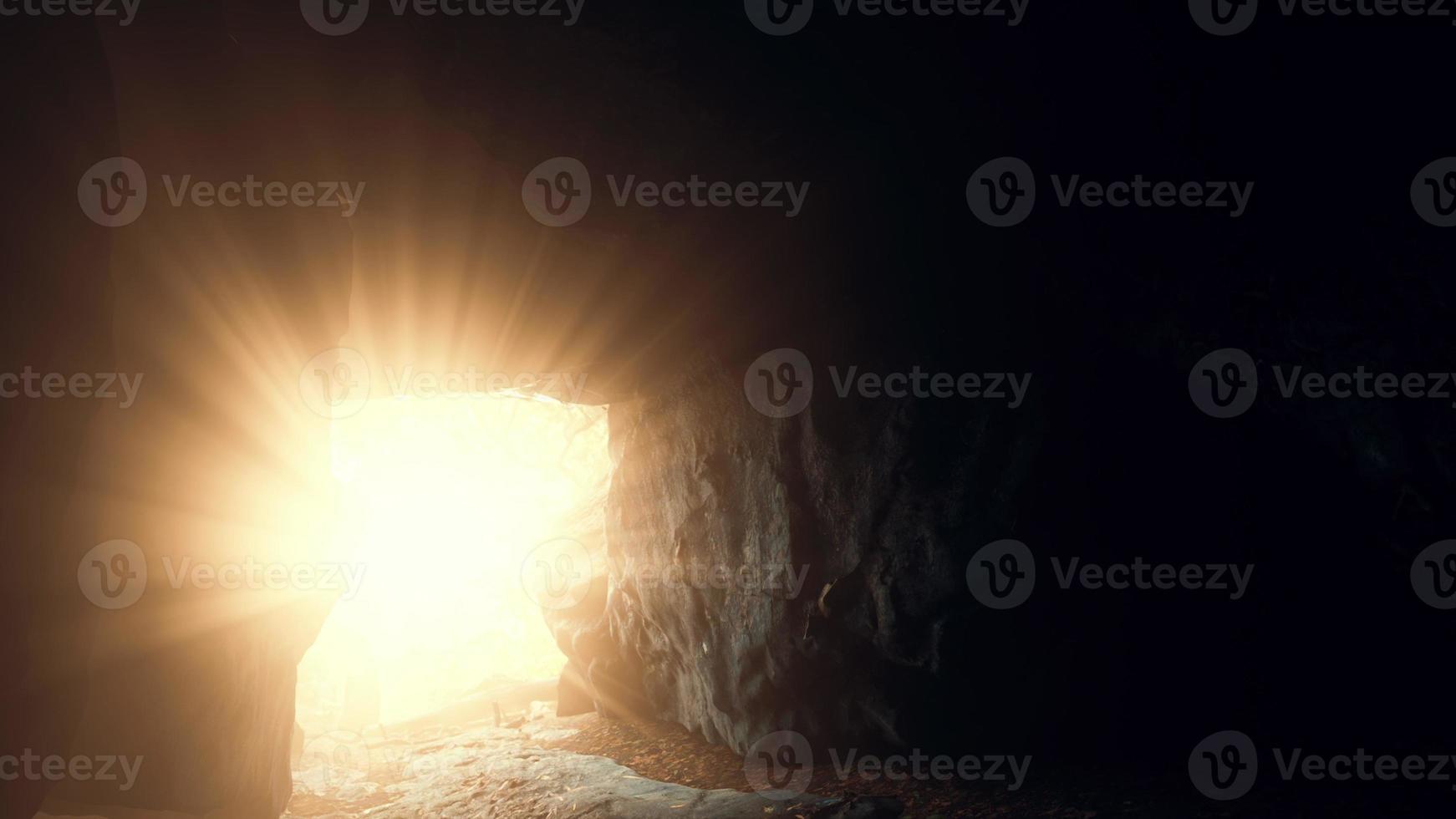 breathtaking scenery of bright sun rays falling inside a cave illuminating photo