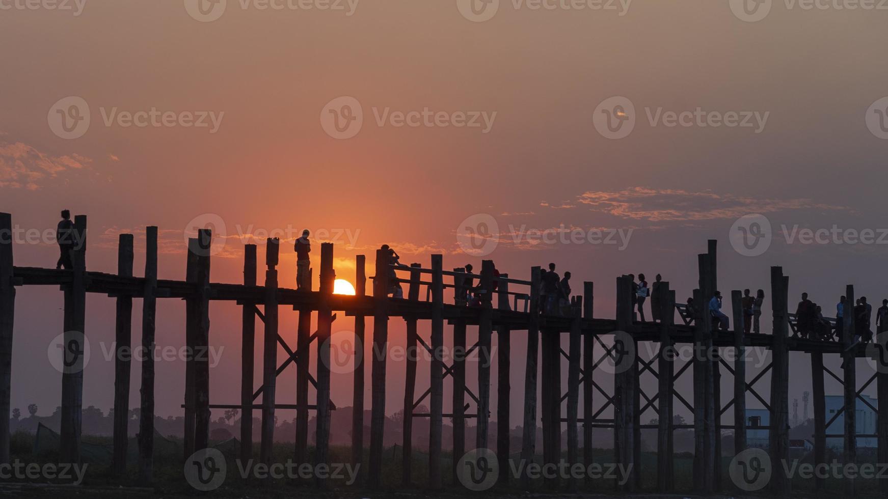 sunset and silhouette at U Bein Bridge, Myanmar, Burma photo