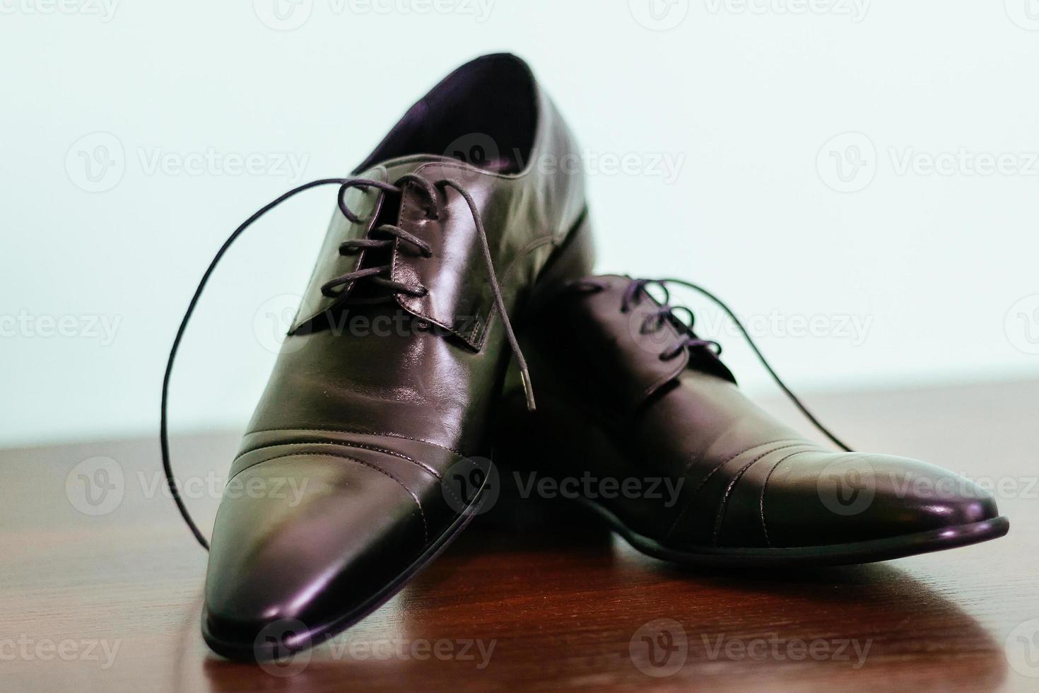 groom tying shoe laces photo