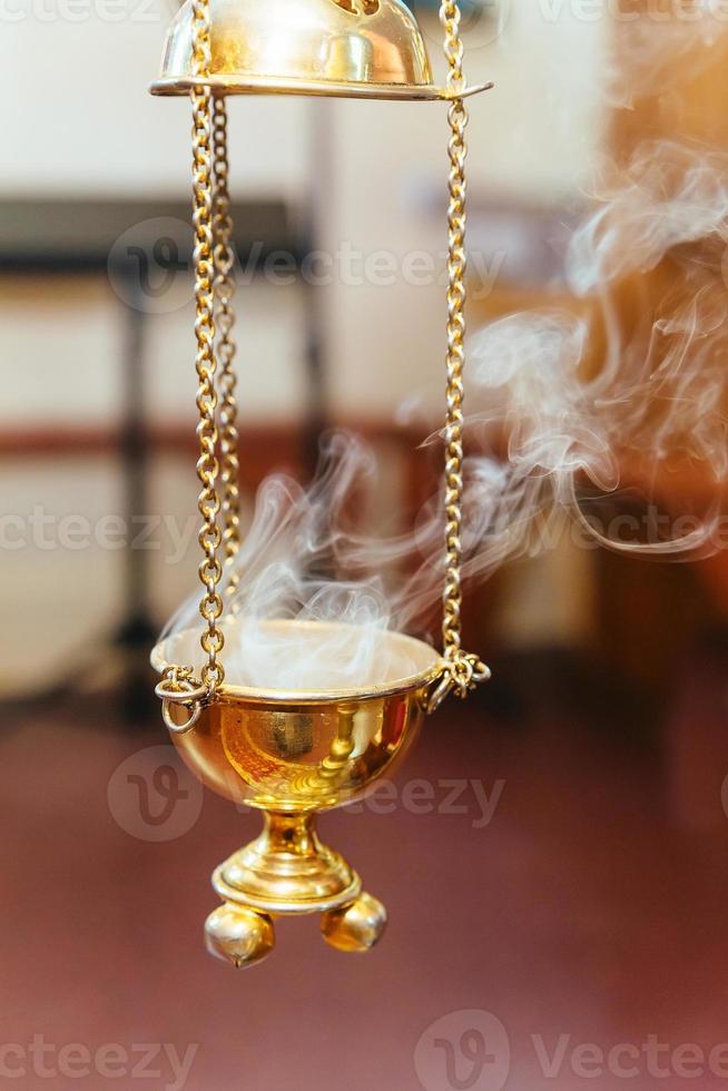 priest singing in a christian sermon censer church rite foog photo