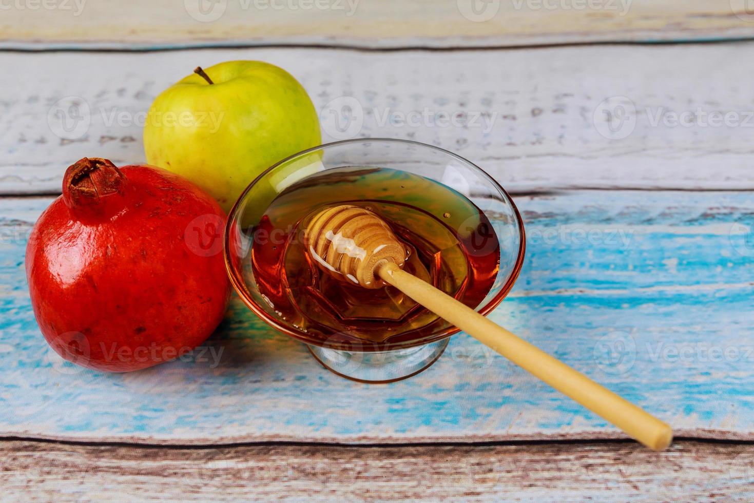 Pomegranate, apple and honey, traditional food of jewish New Year celebration, Rosh Hashana. photo