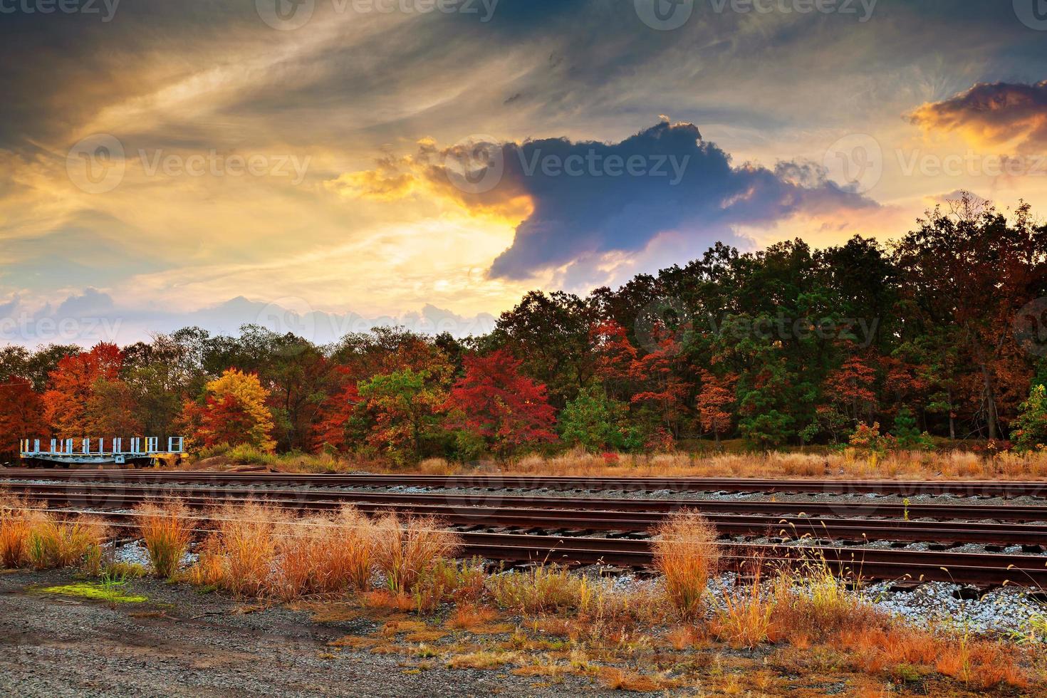 Colorful autumn sunset with sun rays coloring the clouds photo