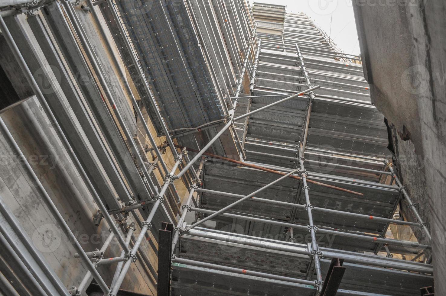 Temporary scaffold for construction works at building site photo