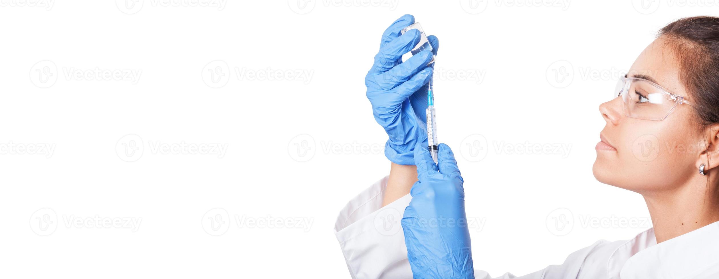 Doctor holding a syringe with vaccine against corona virus. photo