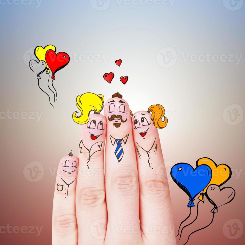 Finger puppets of loving parents with young child hugging and having fun. photo