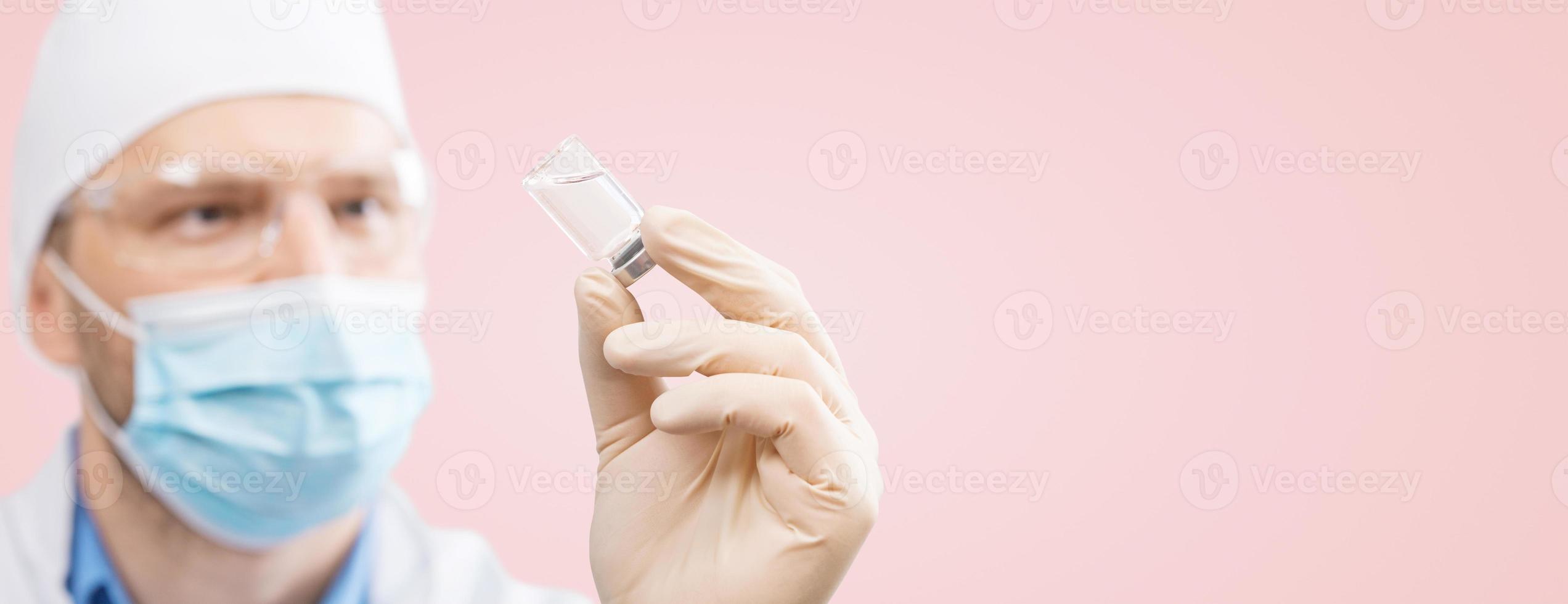 Doctor holding a viol with vaccine against corona virus. photo