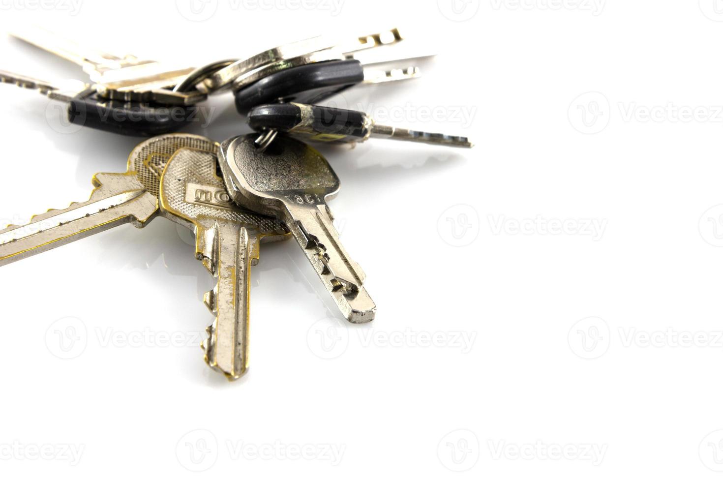 Large bunch of keys isolate on white background photo