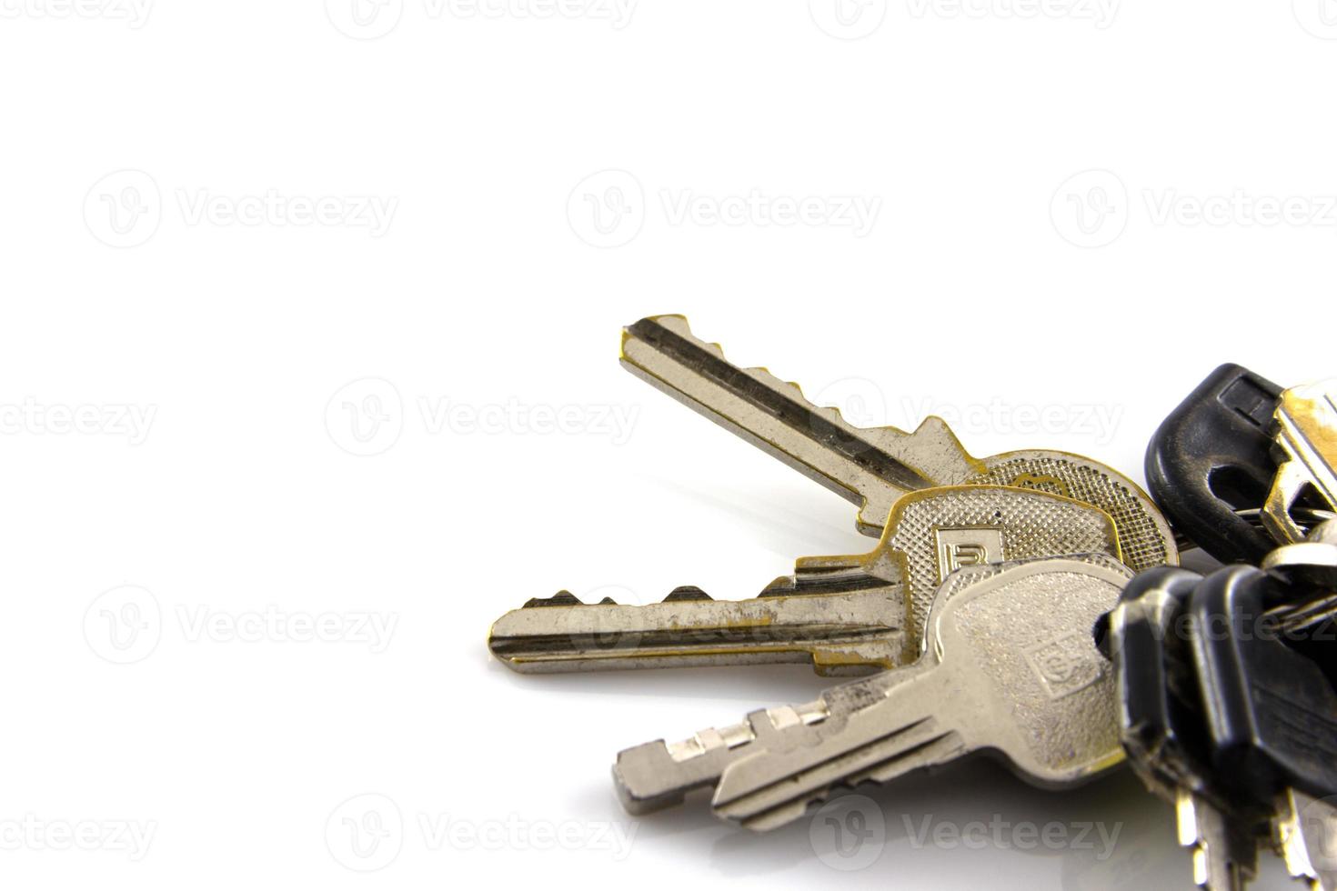 Large bunch of keys isolate on white background photo