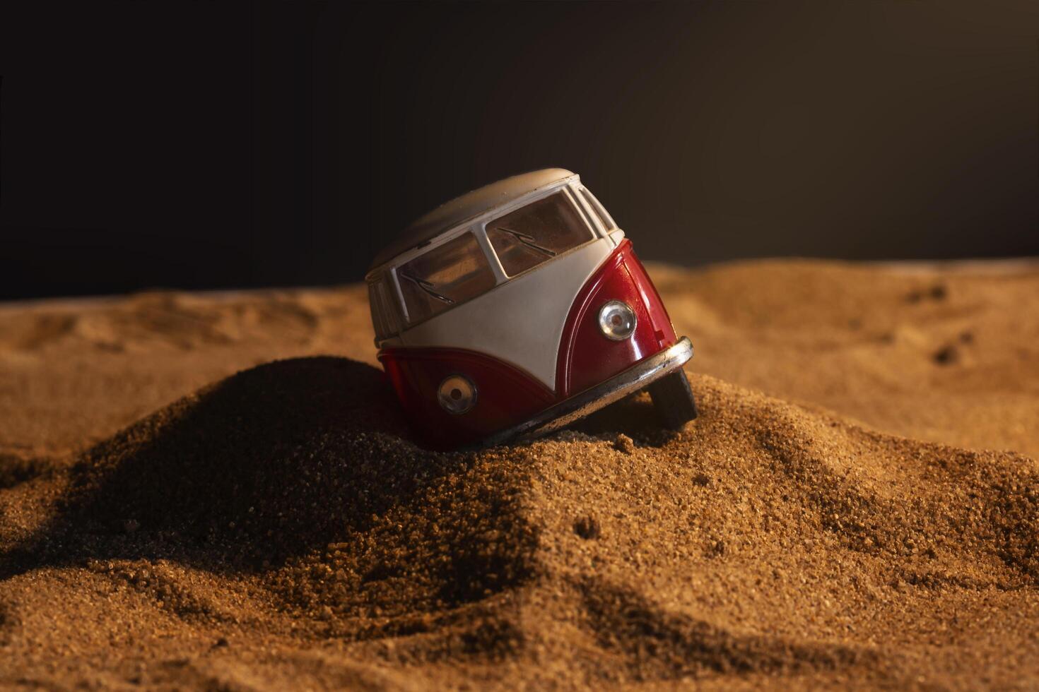 damaged van in sand field with shadow background photo