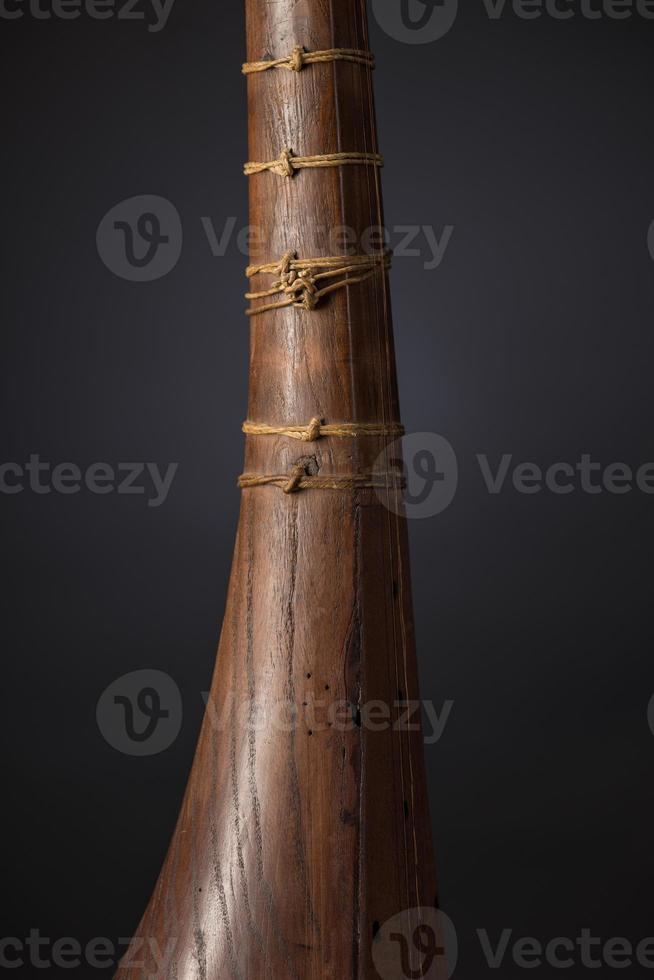 part ancient Asian stringed musical instrument on black background with backlight photo