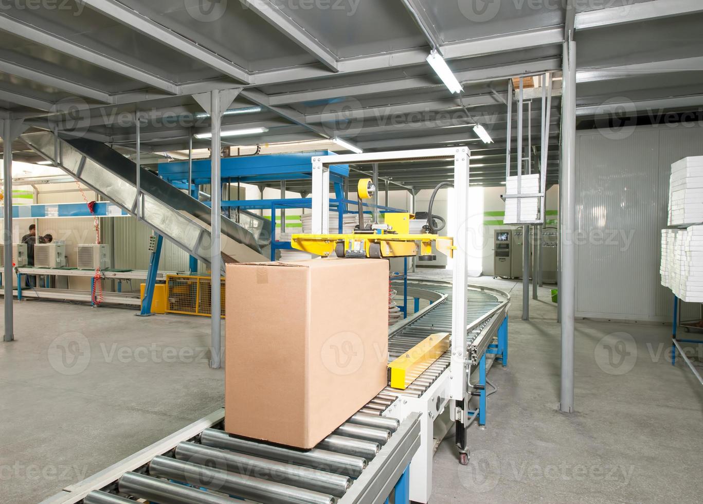 packed electrical engineering cardboard boxes on a conveyor belt in factory photo