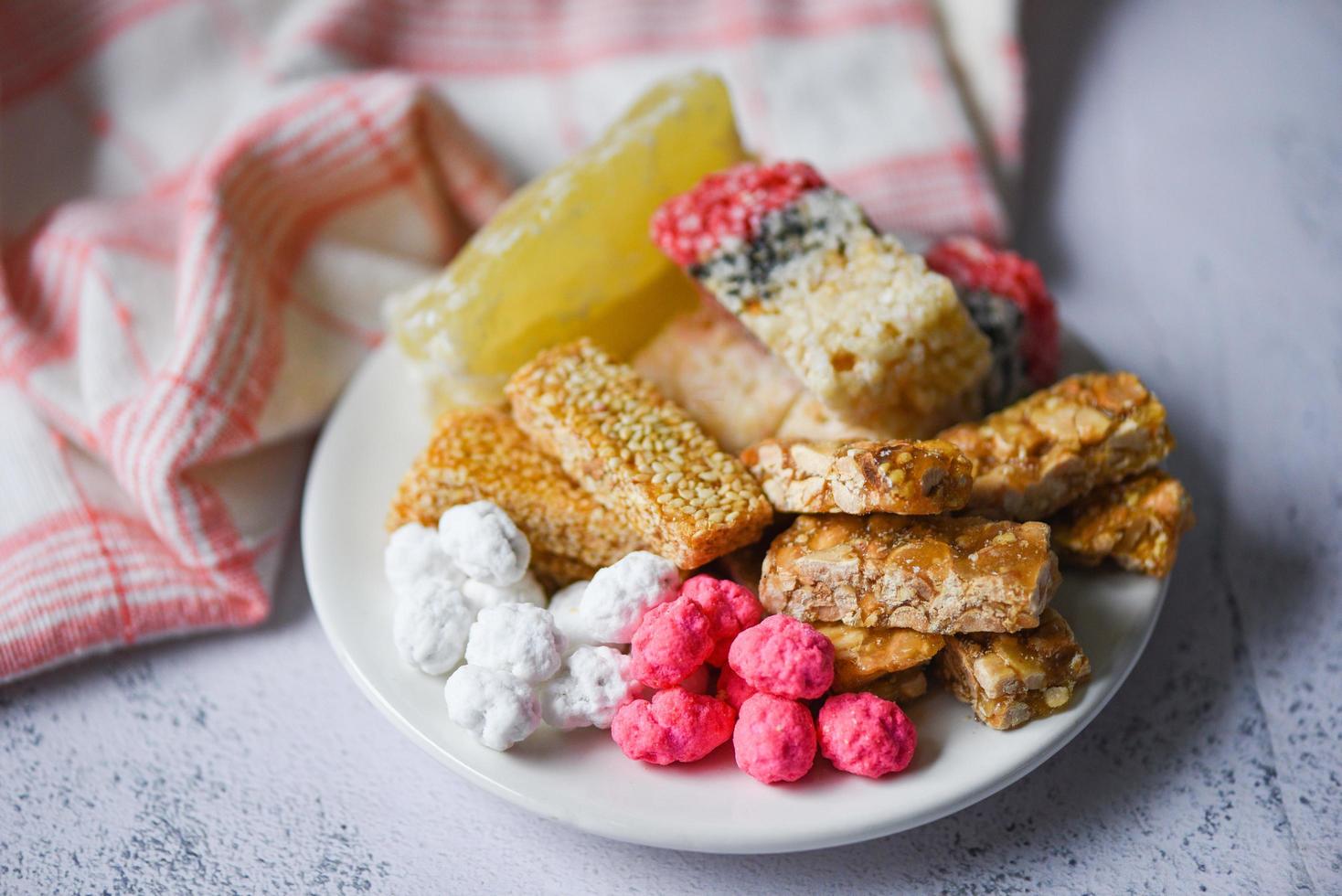 Chinese desserts, Snack mix nuts candies sweets sugar sliced nuts sesame seeds coated beans grains puffed rice candied winter melon, Thai and chinese pay respect to god in chinese new year festival photo