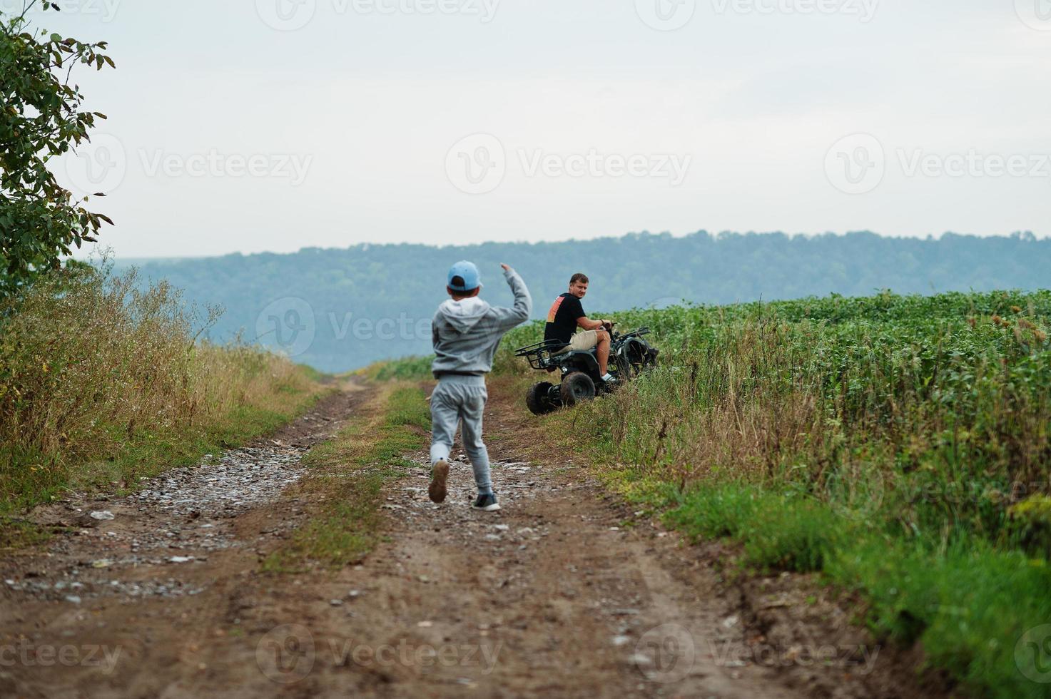 Man driving four-wheller ATV quad bike. photo