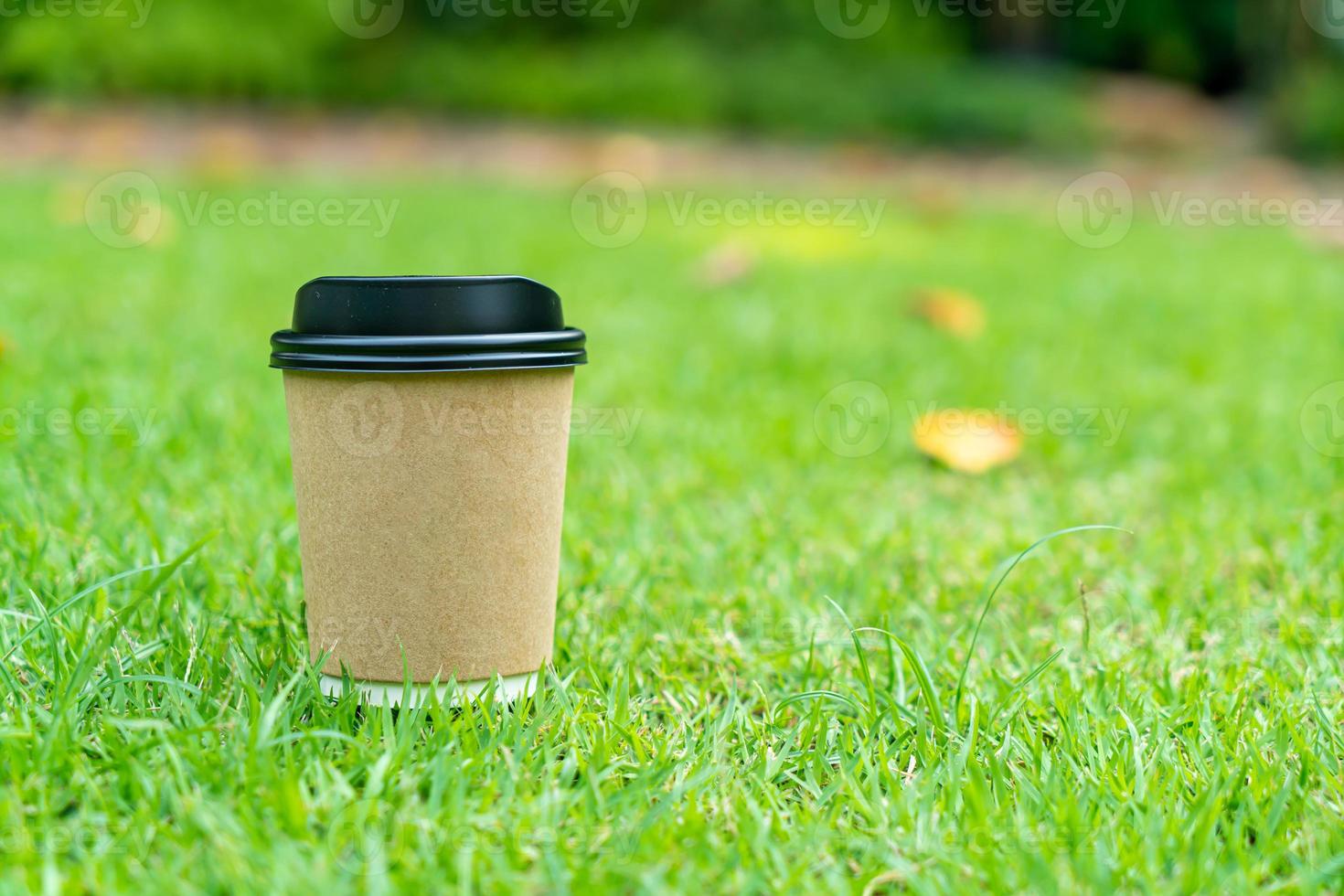 hot coffee cup on grass photo