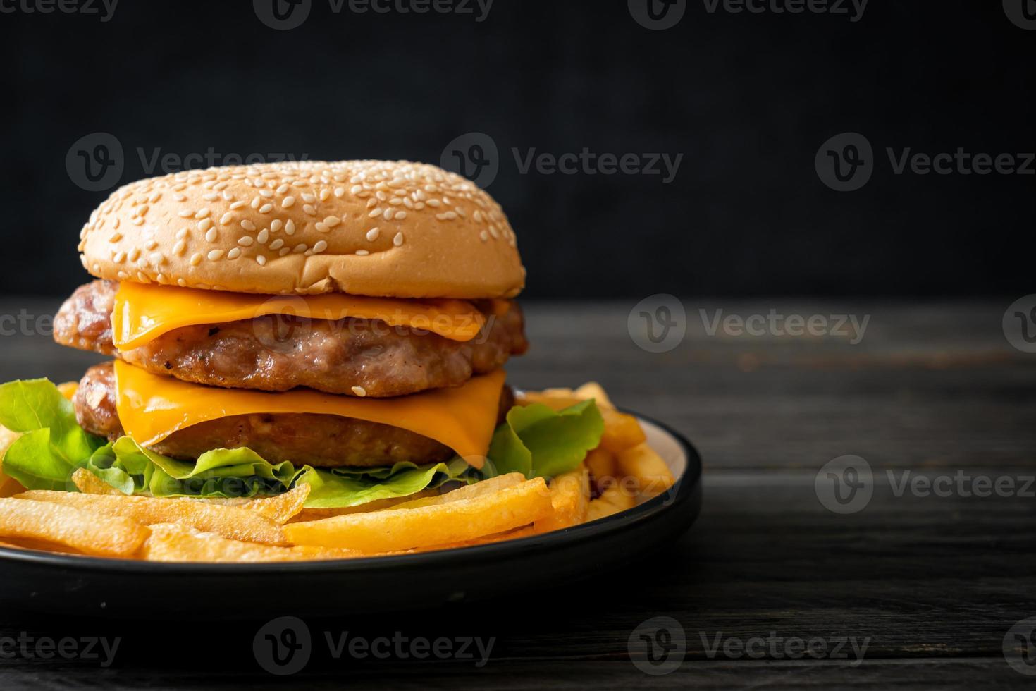 pork burger with cheese and french fries photo