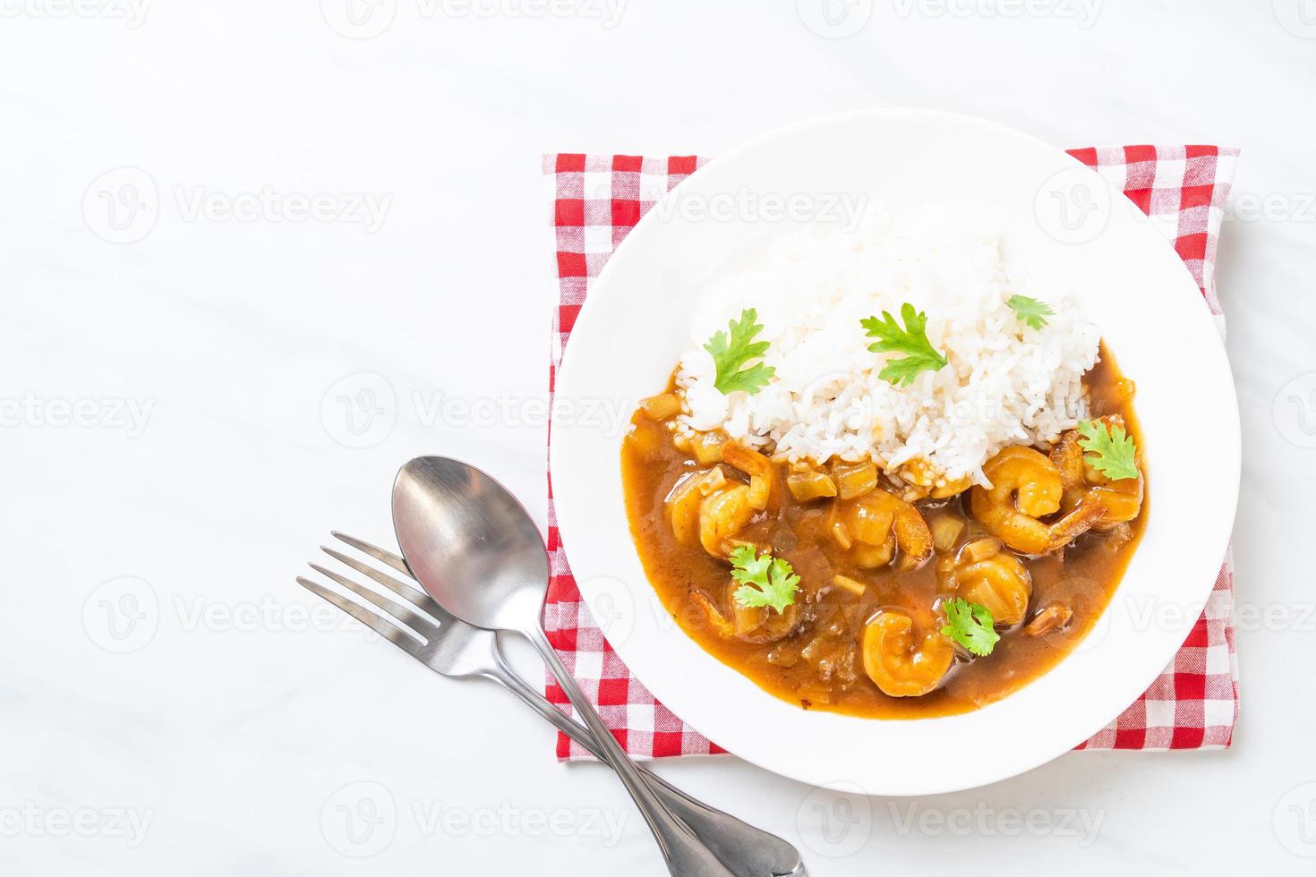 Shrimps in curry sauce on rice photo