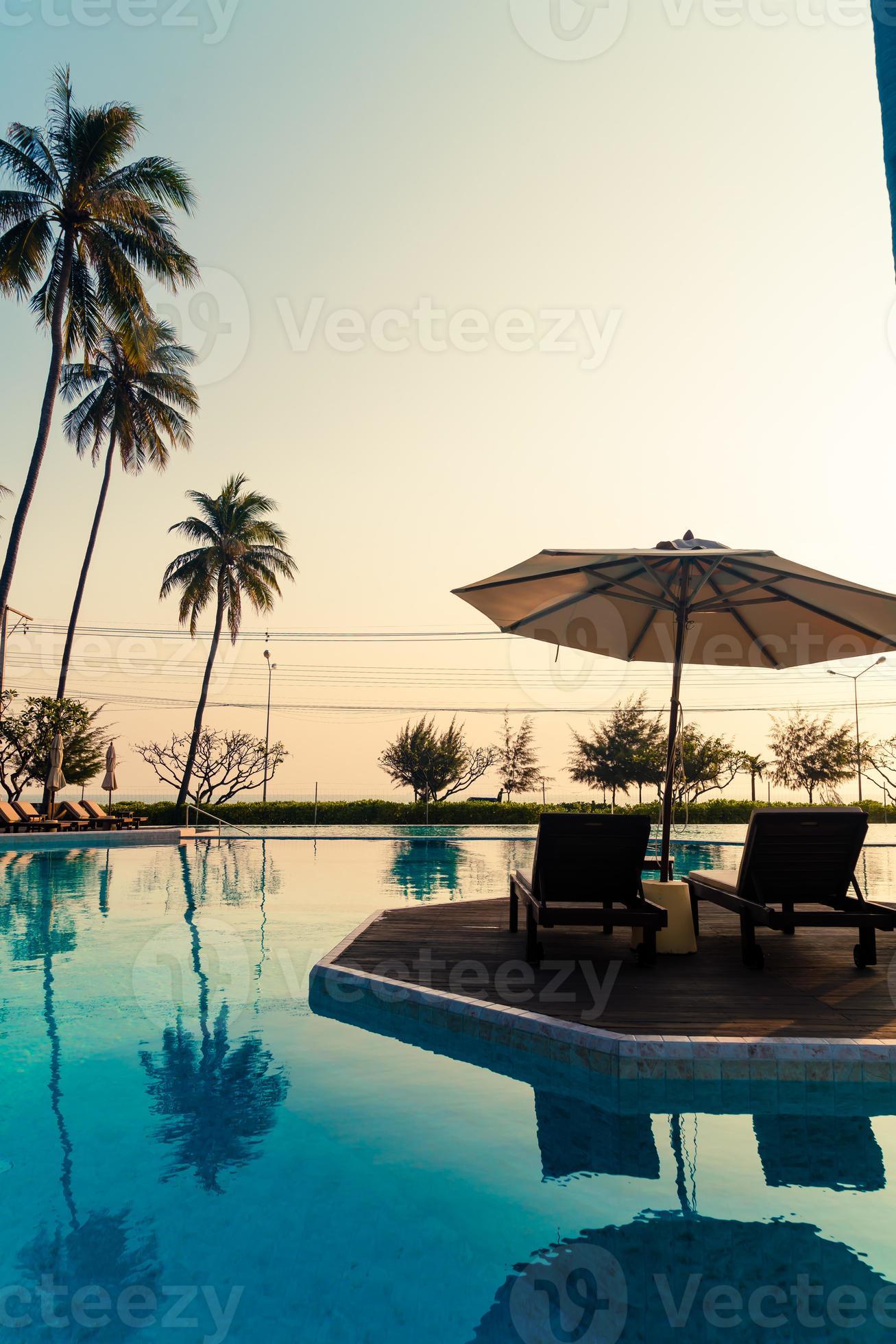 umbrella with bed pool around swimming pool with ocean sea background