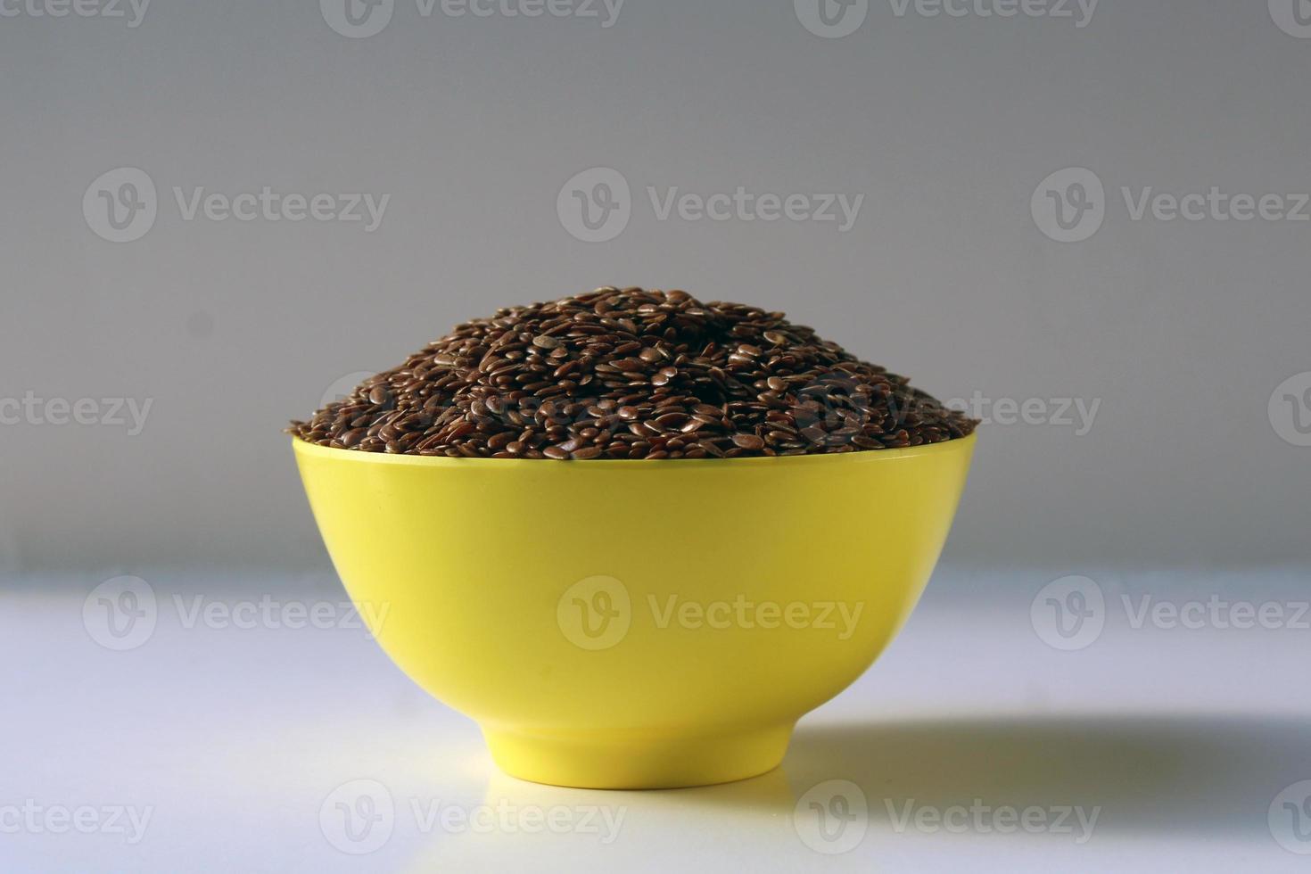 bowl of flax seed isolated on white background, top view photo