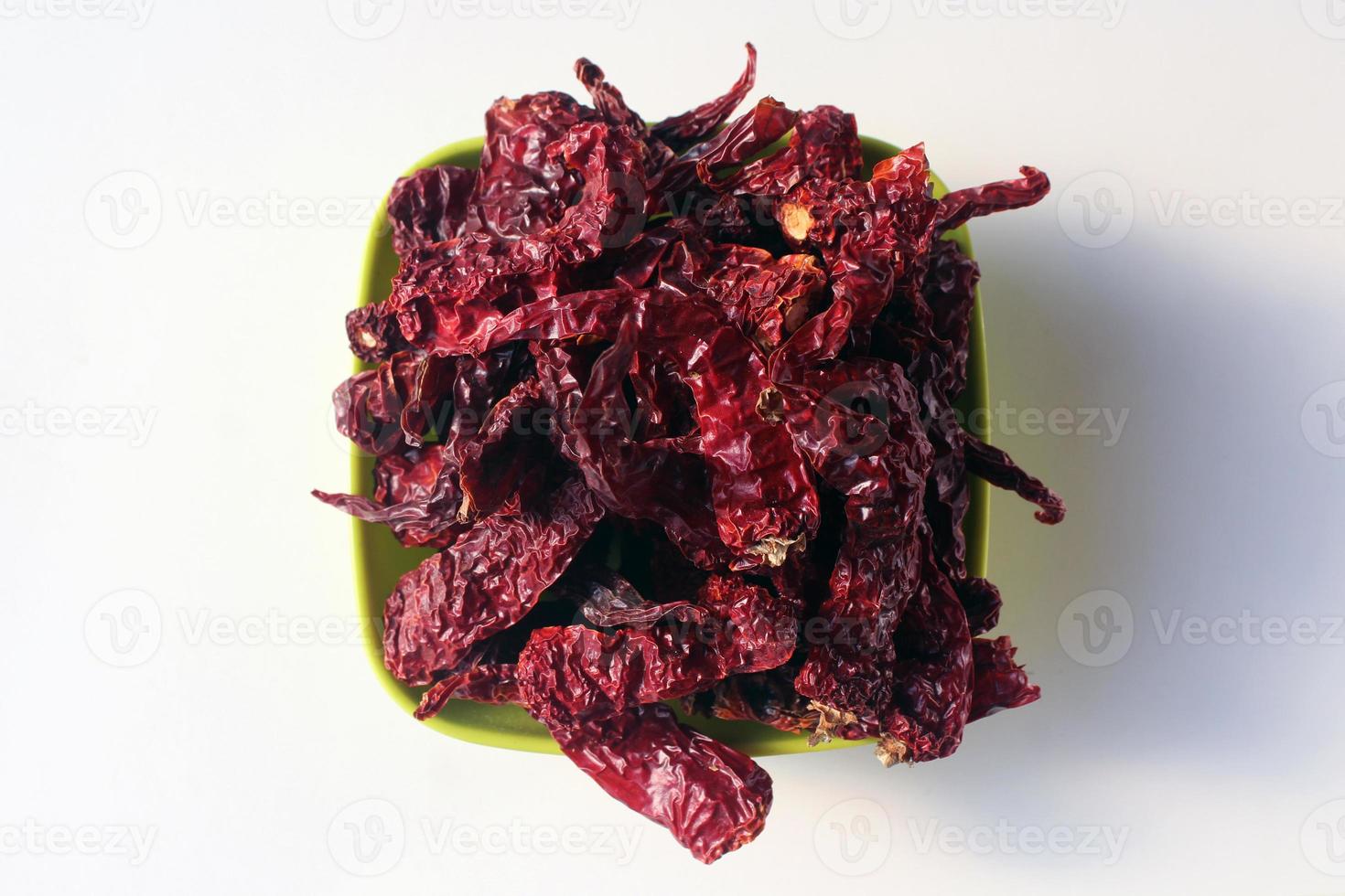 Byadgi Red Dry Chili or Bedgi Mirch, Lal Mirchi on white background. It is a famous variety of chili mainly grown in the Indian state of Karnataka. photo
